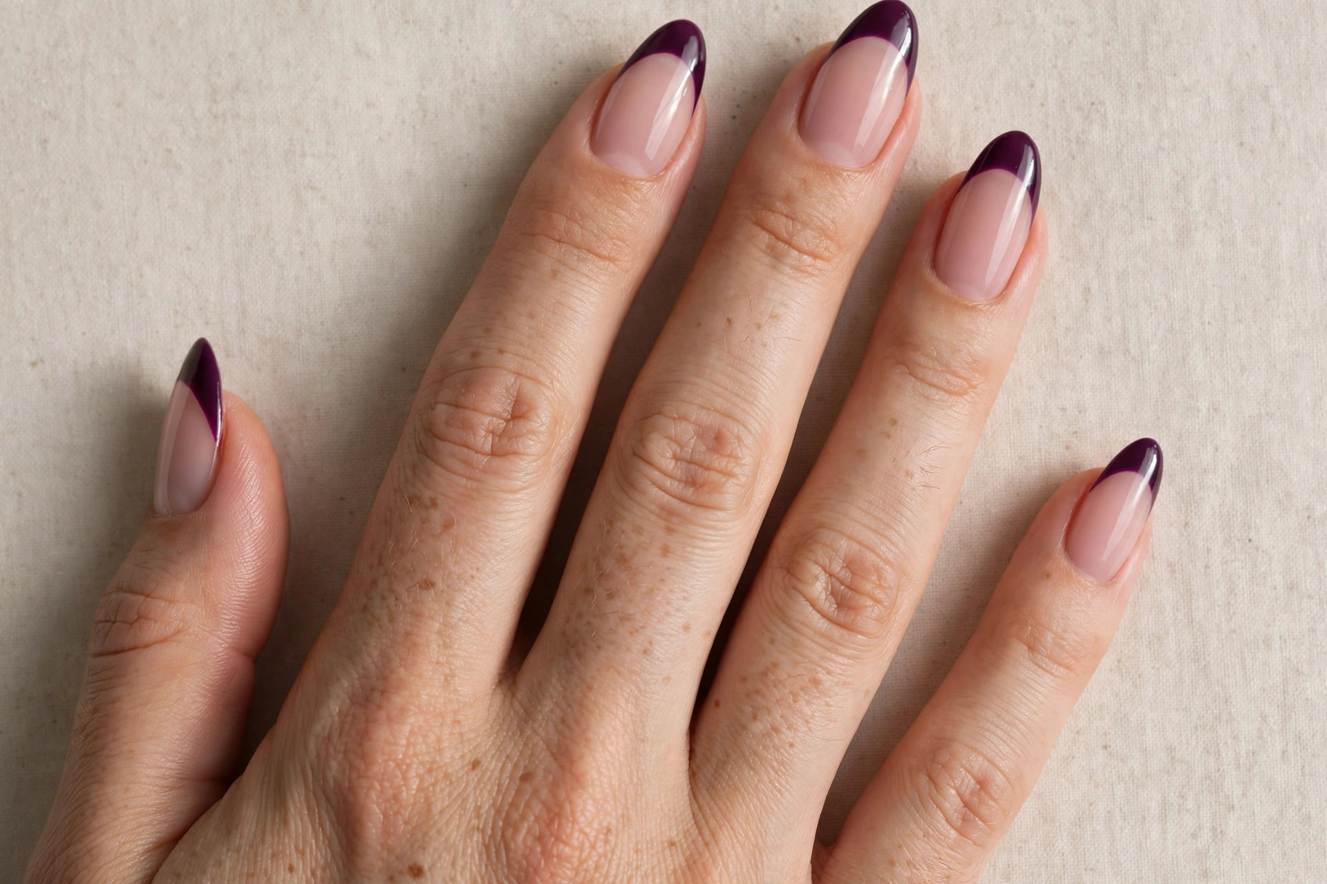 Deep plum purple French tips on a sheer blush base for fall