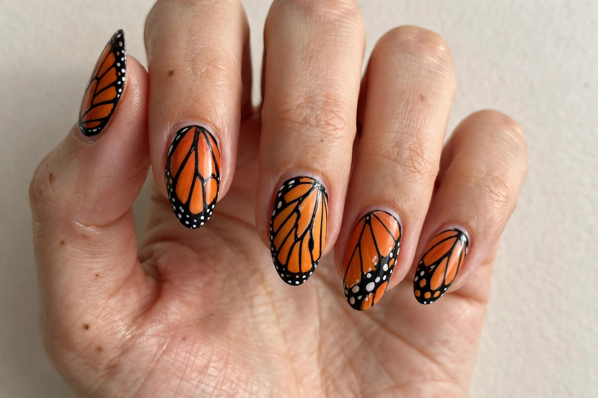Butterfly wing print nails in orange and black