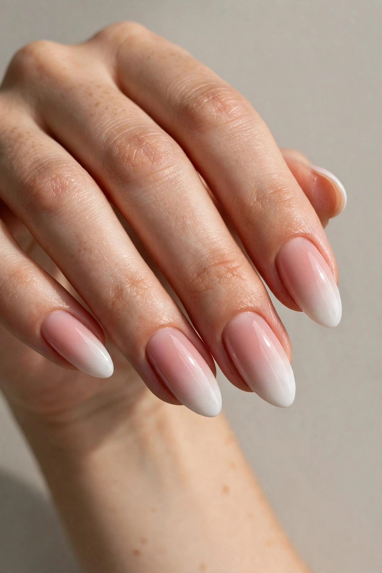 Baby boomer ombre manicure blending white into blush pink