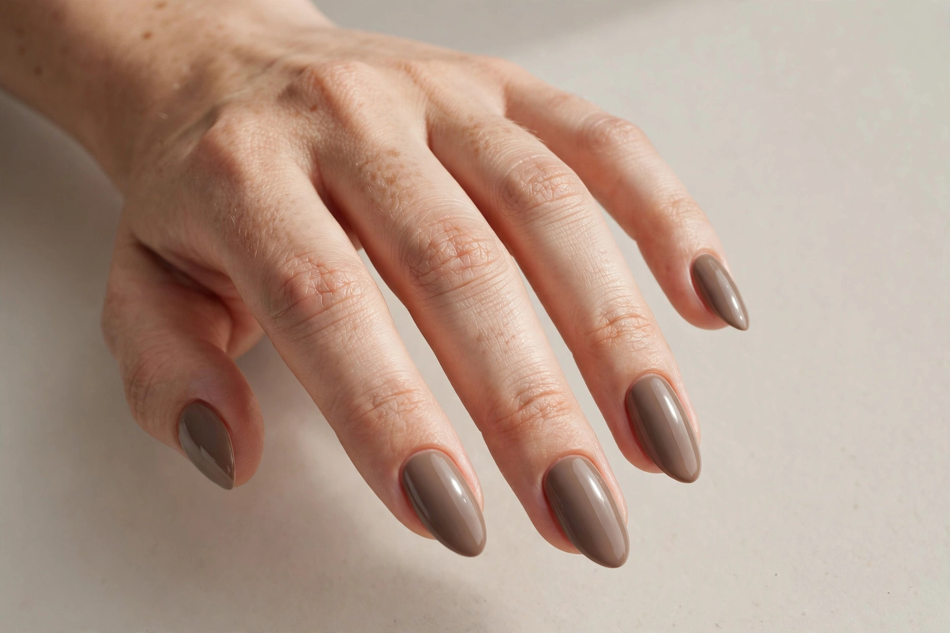 Warm taupe manicure with smooth finish