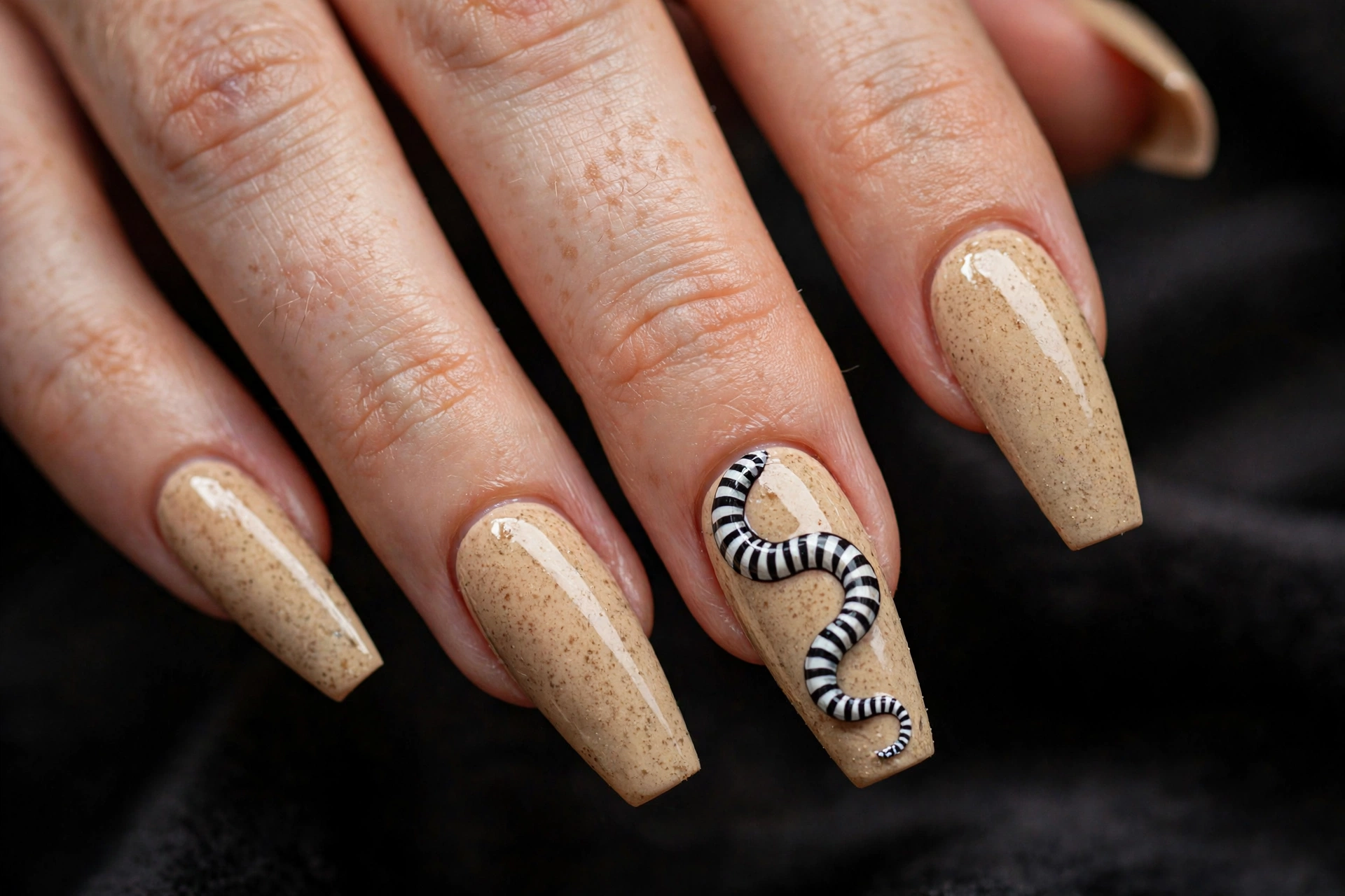 Coffin nails with sandy beige base and hand-painted black and white striped sandworm creature art