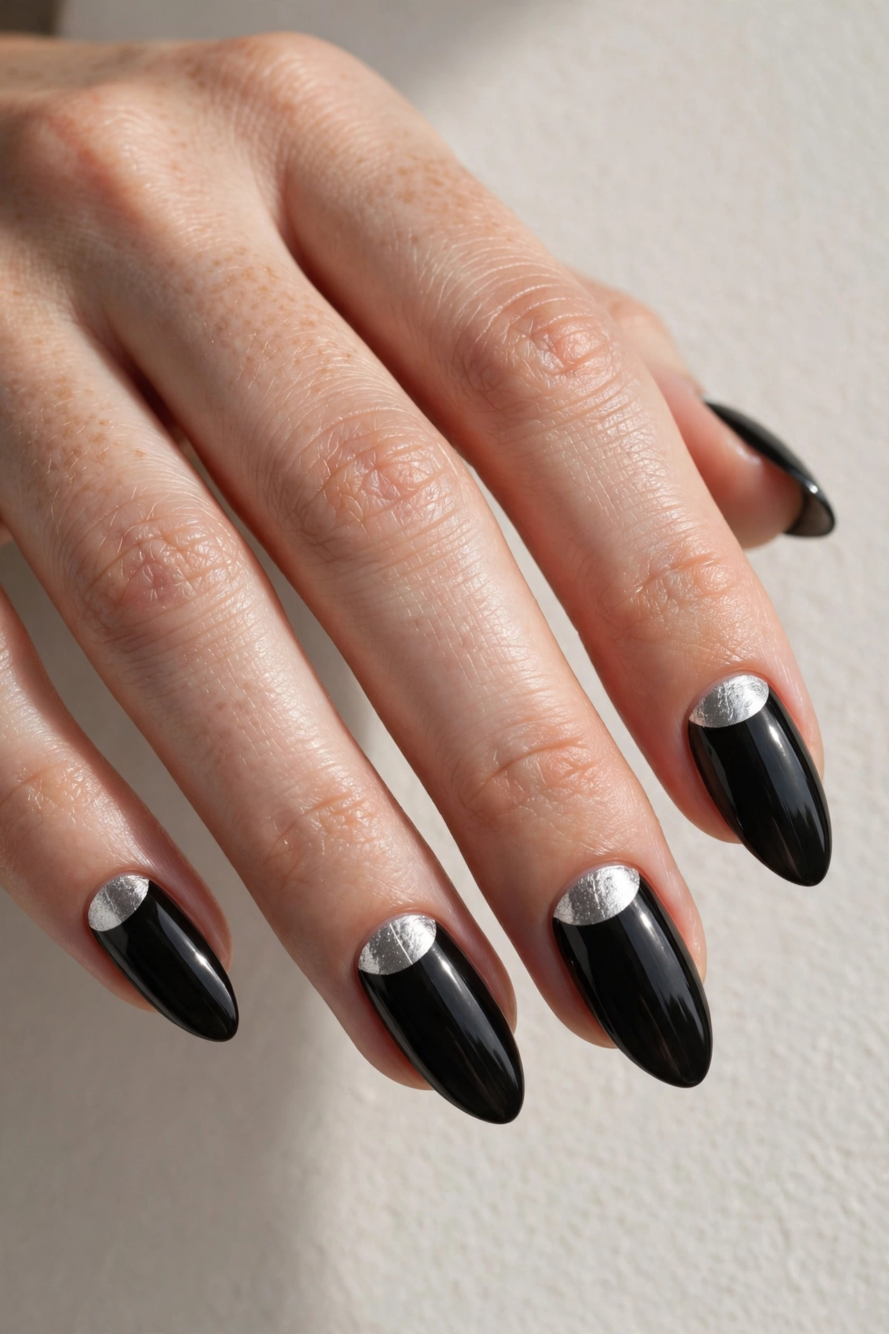 Black nails with silver half-moon cuticle detail