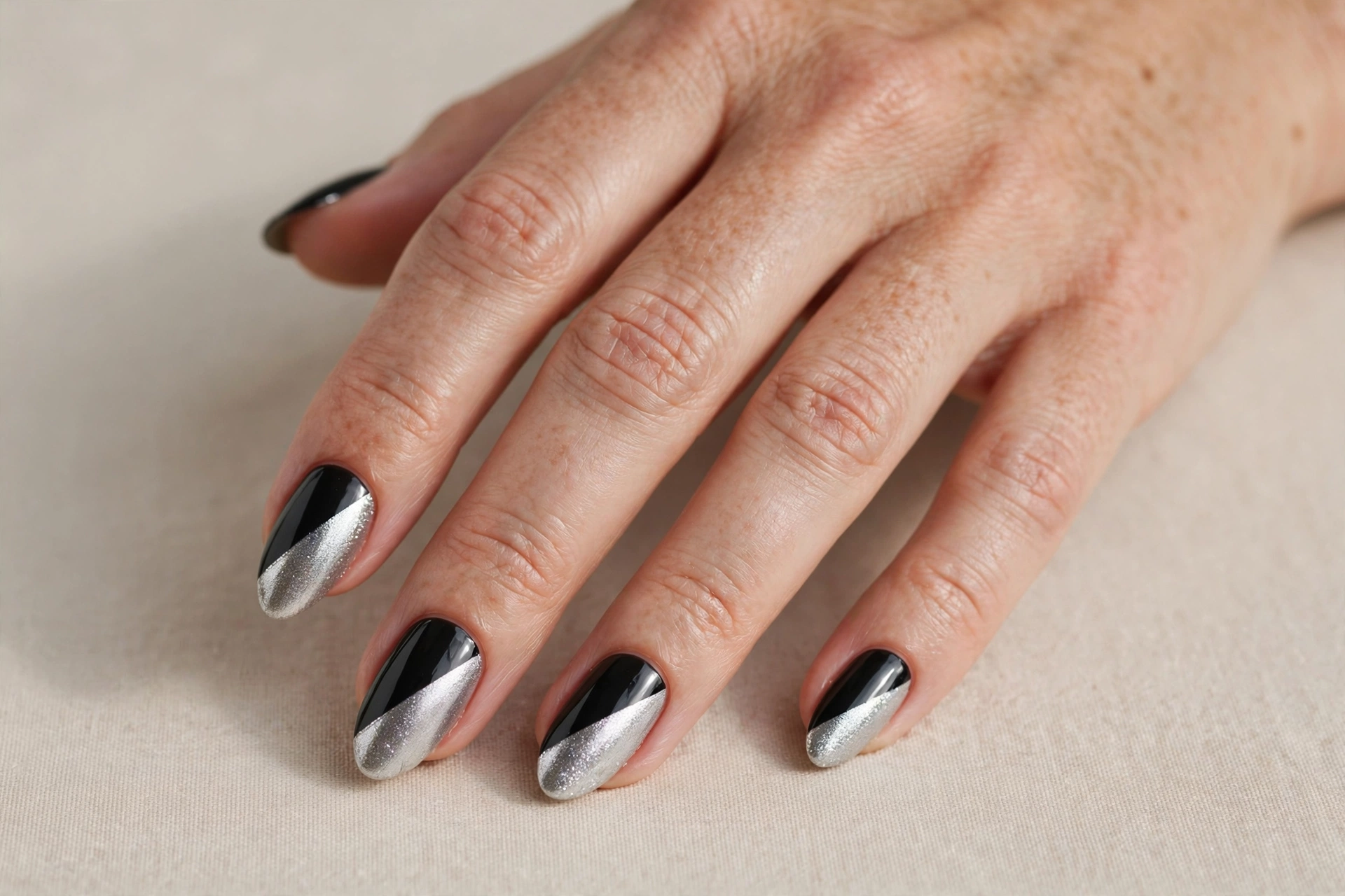 Diagonal black and silver colour block nails