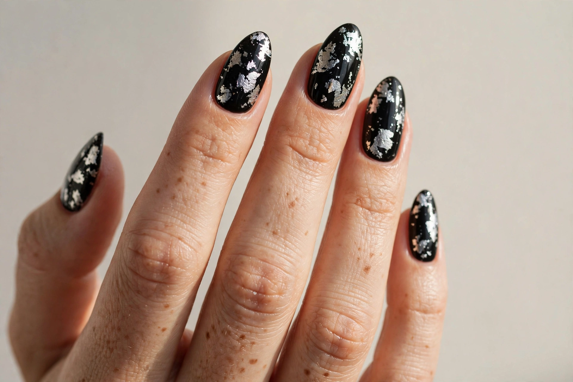 Black nails with silver foil flakes