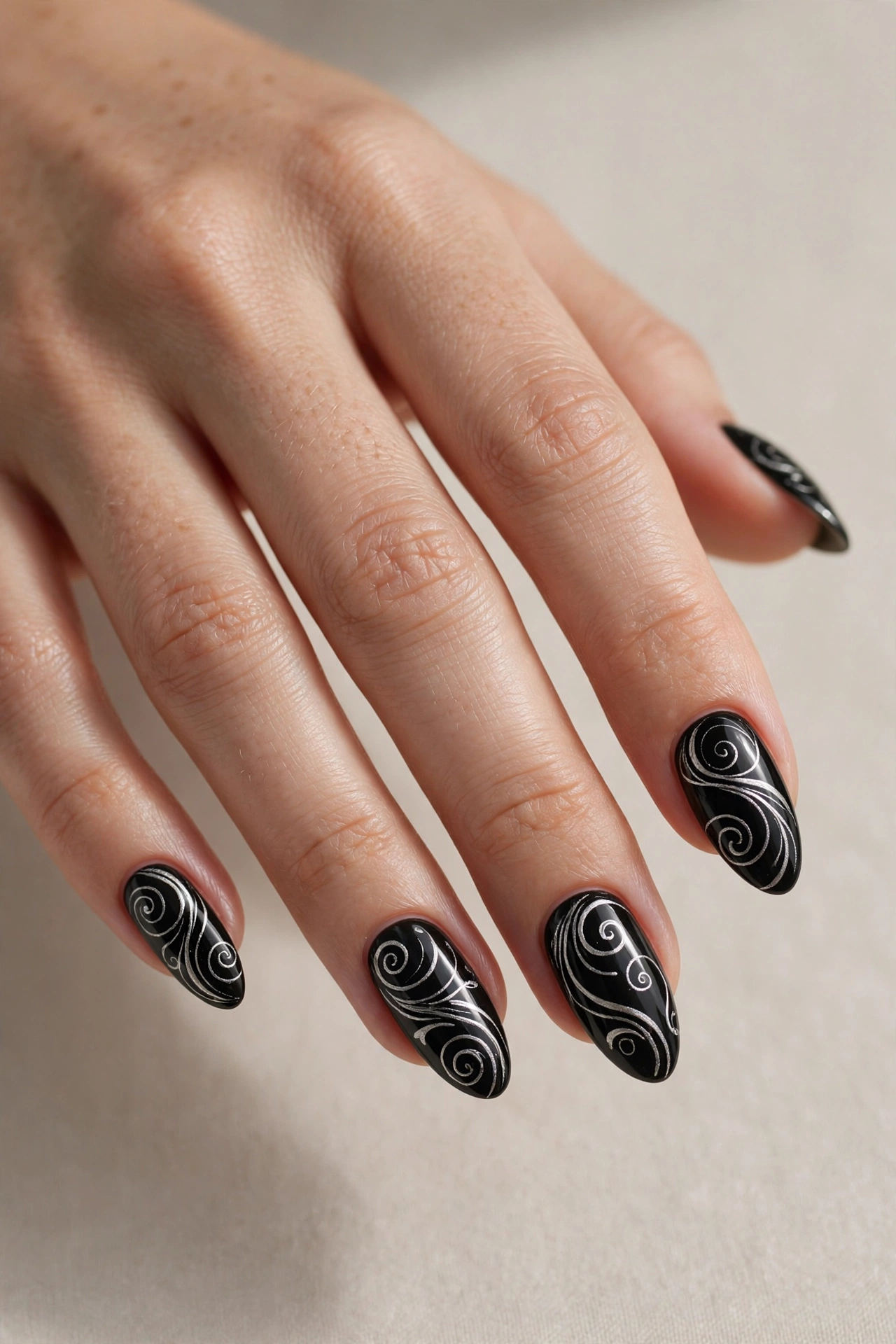 Black nails with silver swirl art