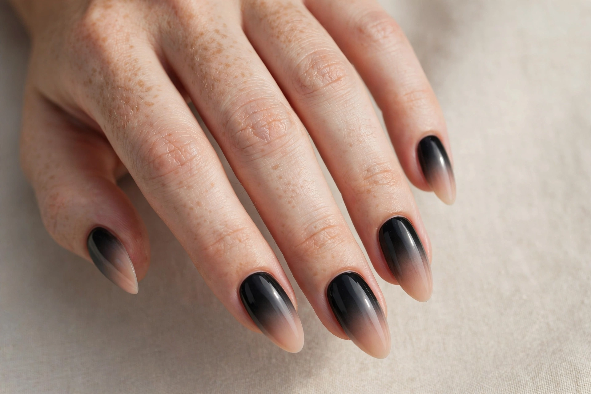 Black ombre nails fading from black to nude