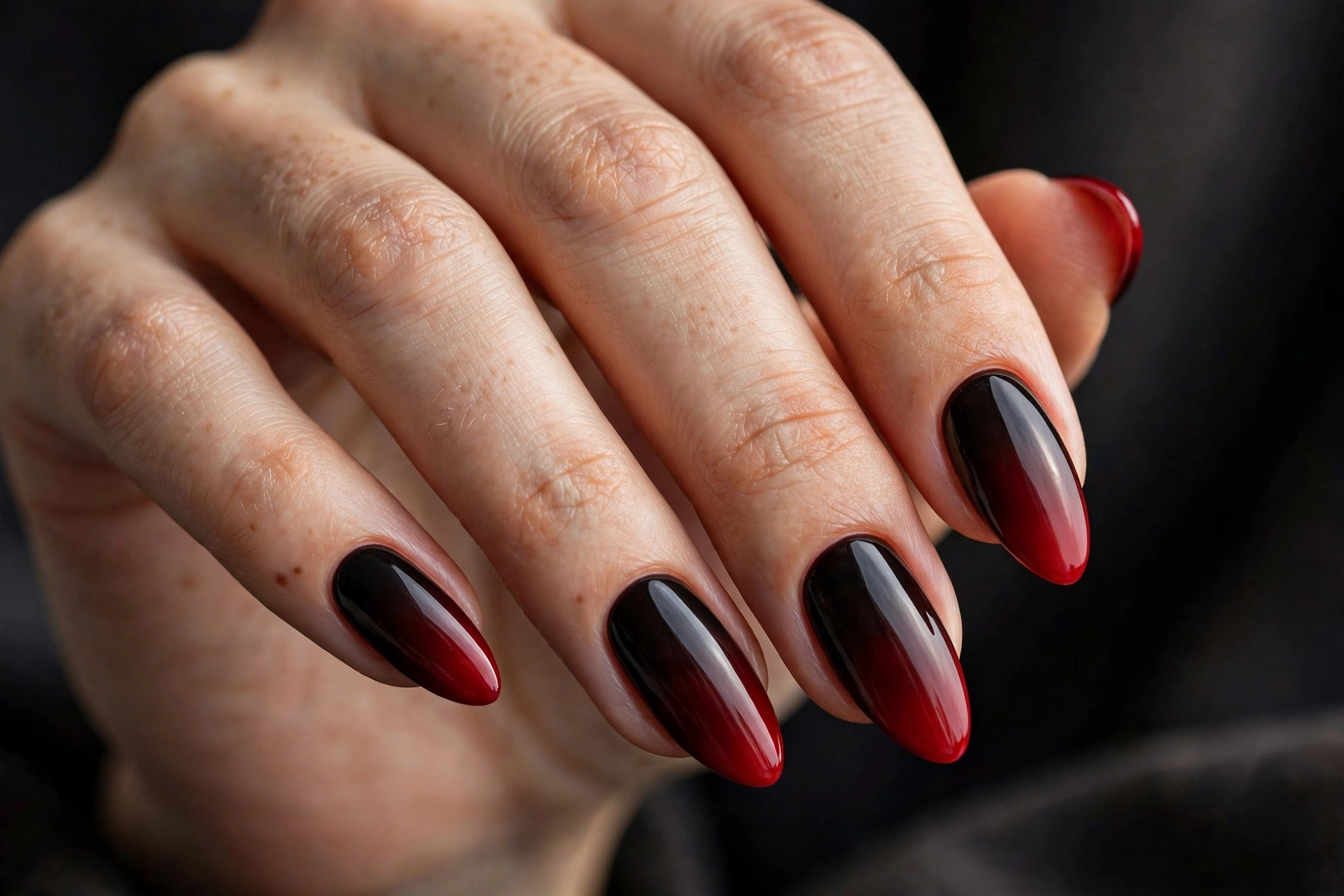 Almond nails with glossy black-to-blood-red ombré gradient