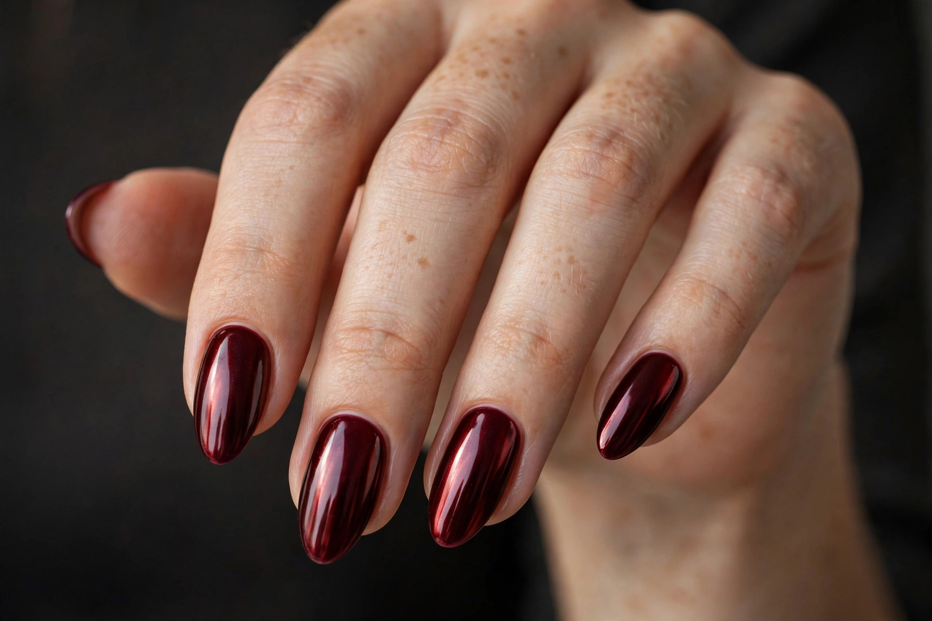 Dark cherry red chrome almond nails with mirror shine