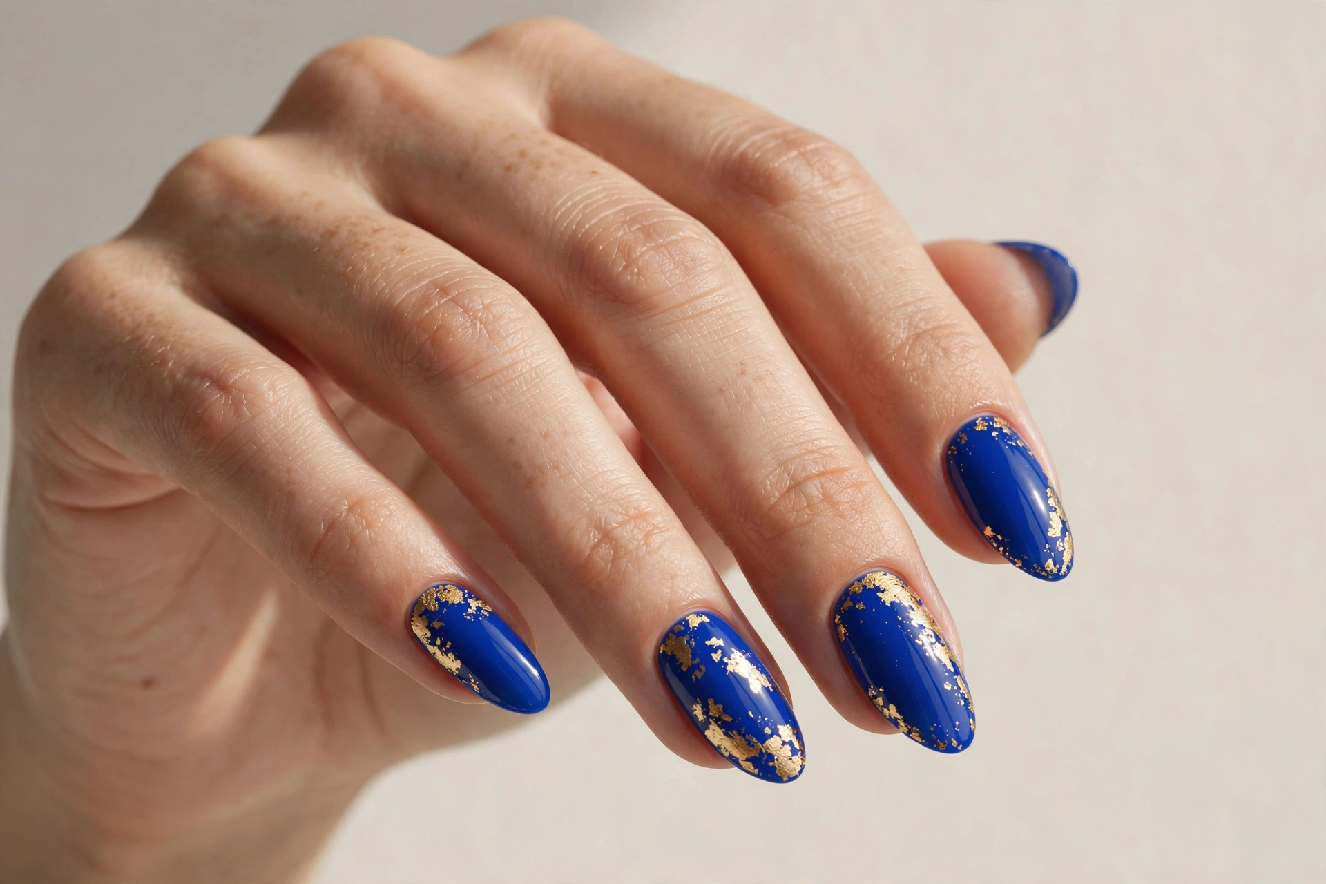 Cobalt blue nails with gold foil accent nail art