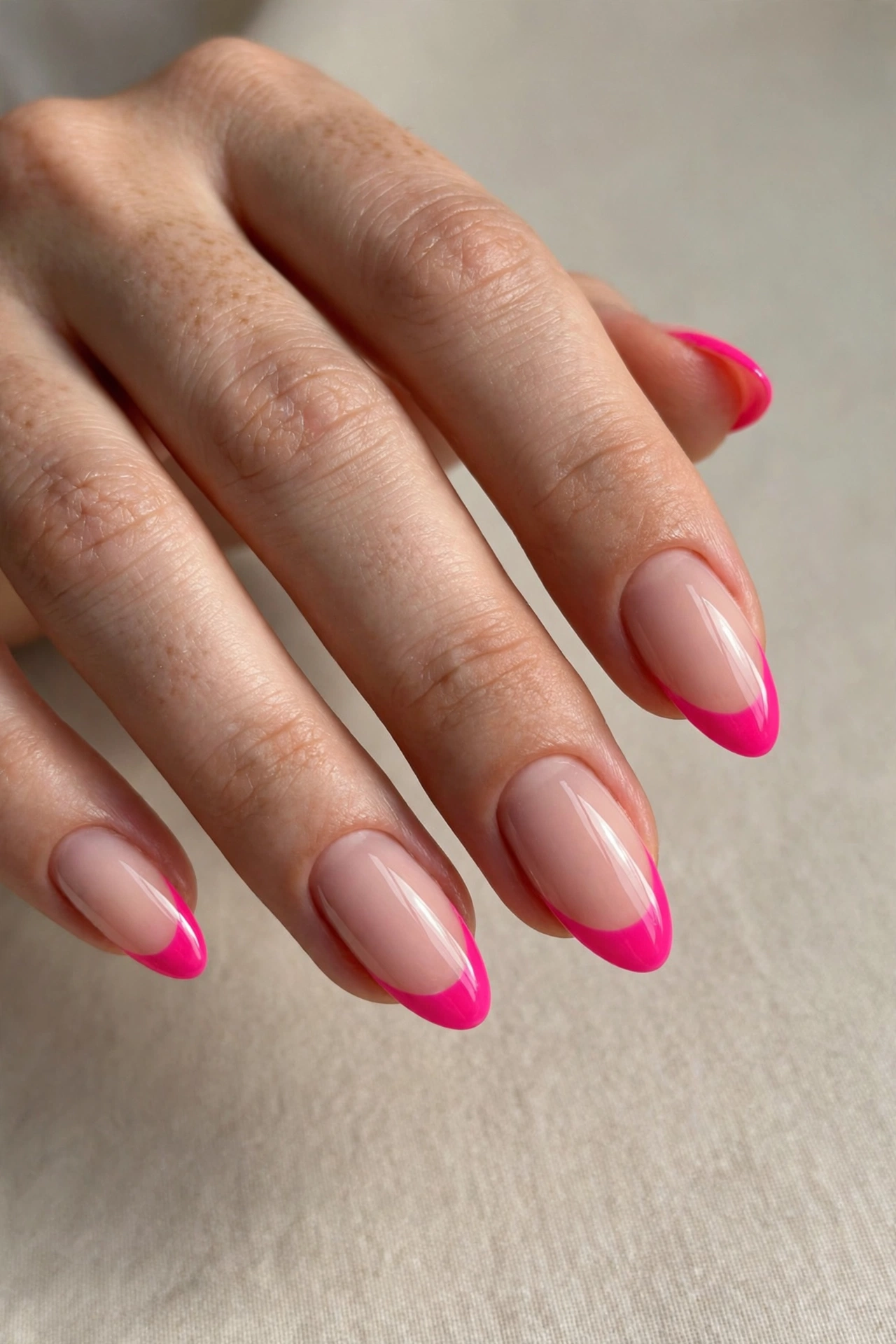 Hot pink French tip manicure on almond shaped nails