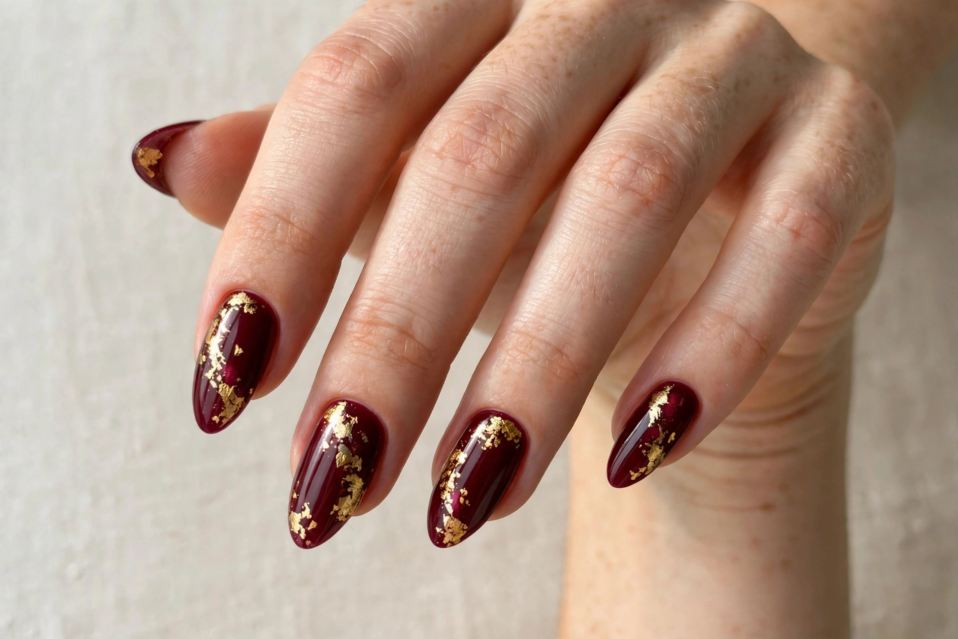 Nude to burgundy ombre gradient nails fading from soft nude to wine red