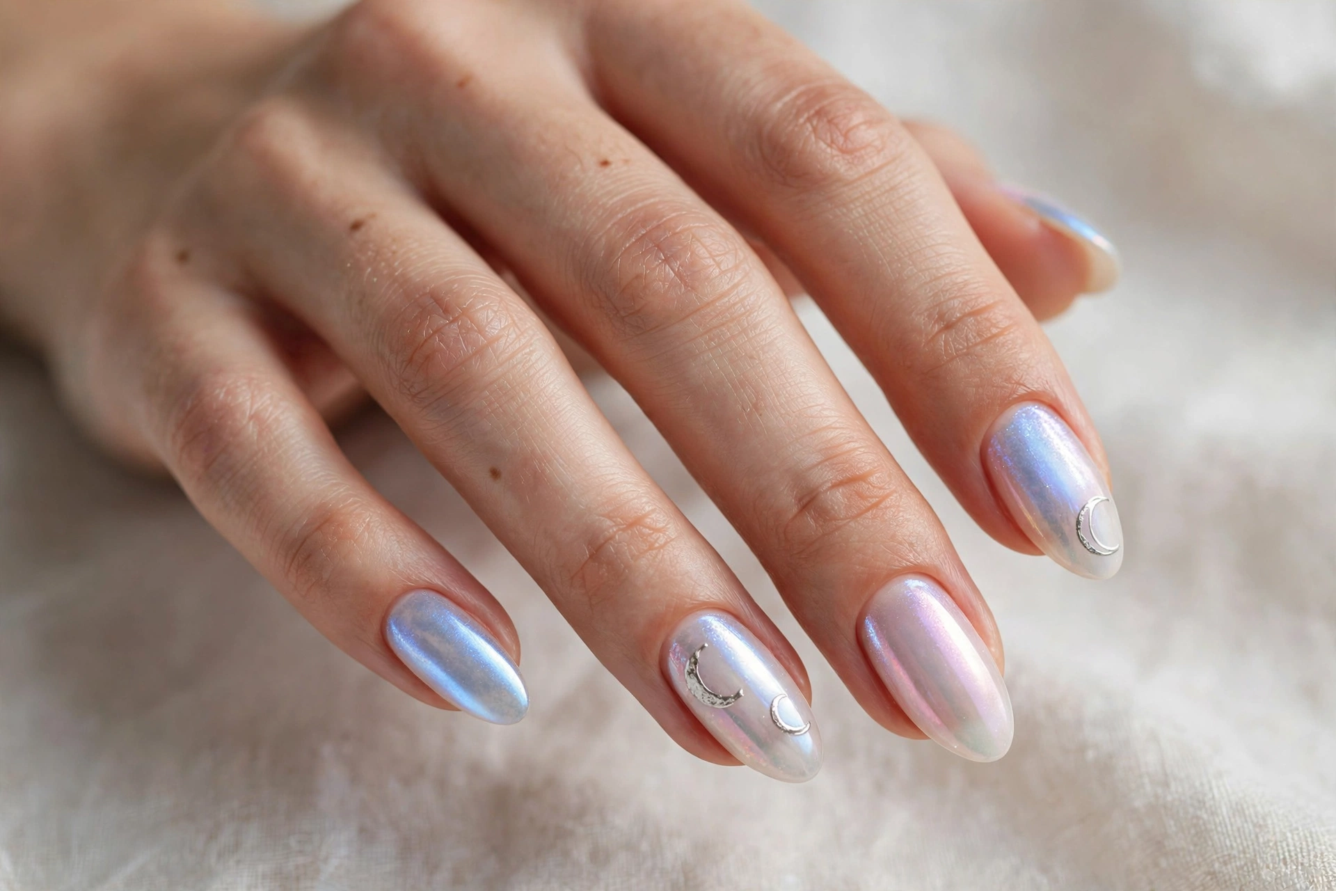 Iridescent moonstone glow nails with opalescent pearl and silver crescents