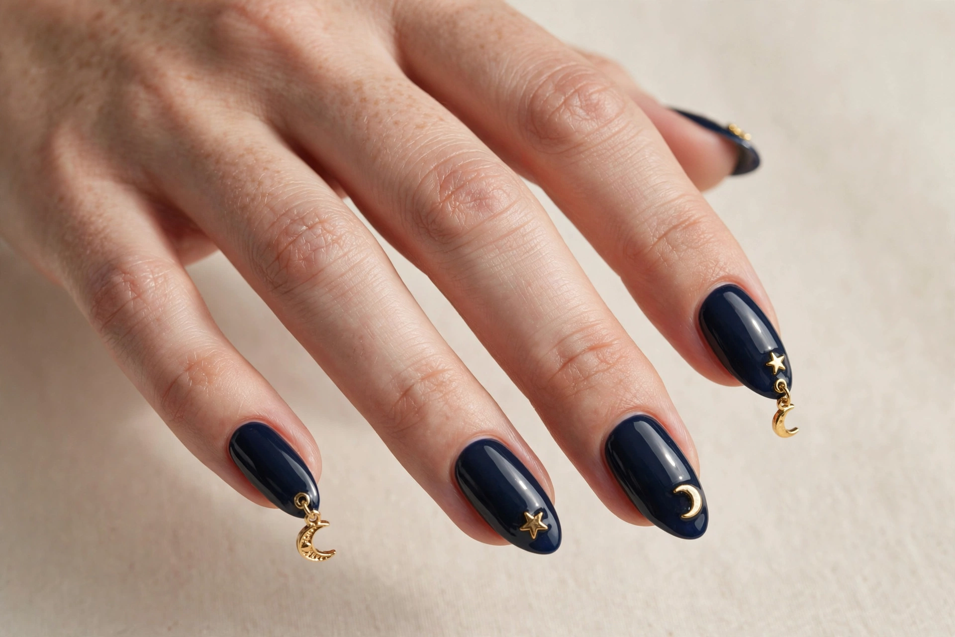 Midnight navy almond nails with crescent moon and gold star charms