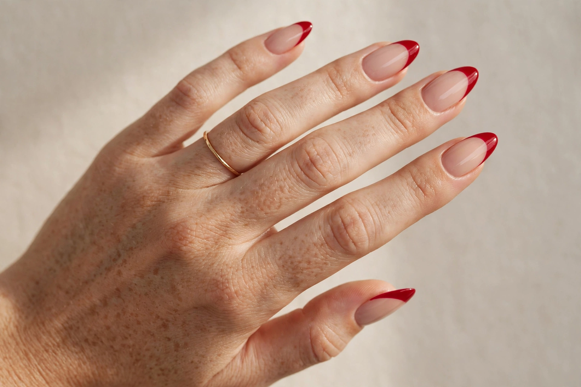 Cherry red French tips on nude base nails