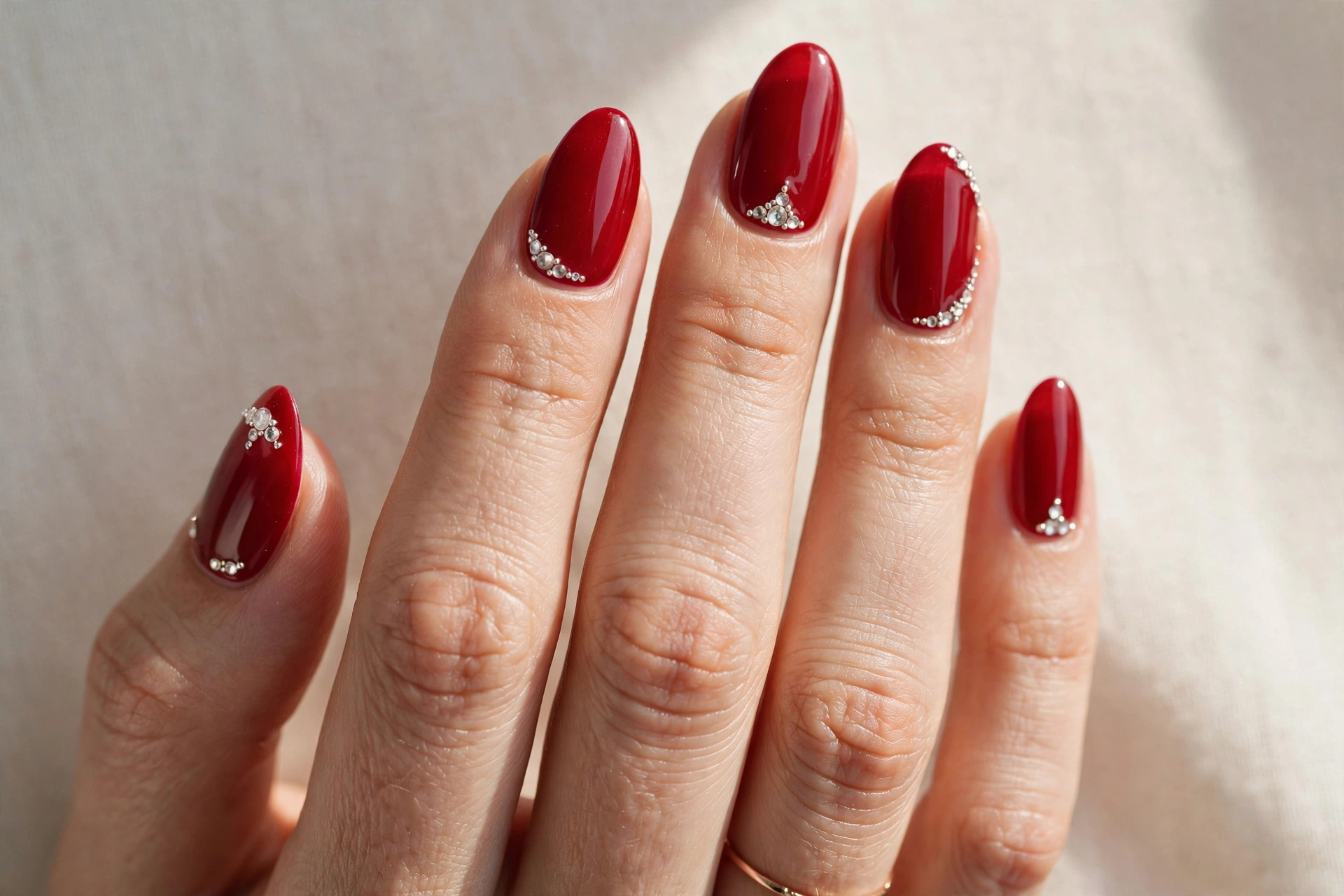 Cherry red nails with crystal rhinestone accents