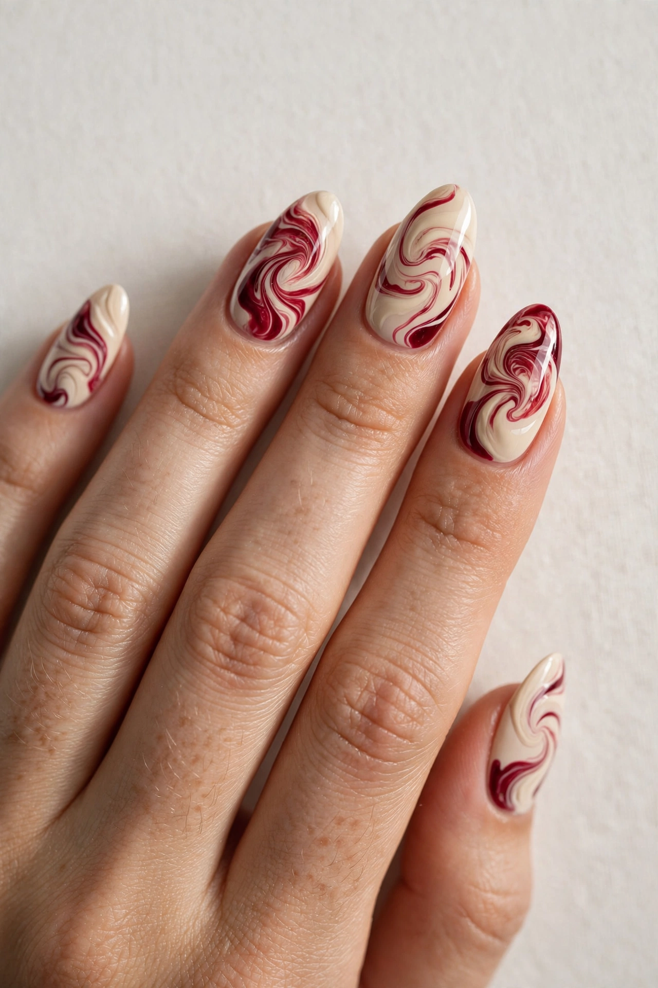 Cream and cranberry abstract swirl press-on nails for Christmas