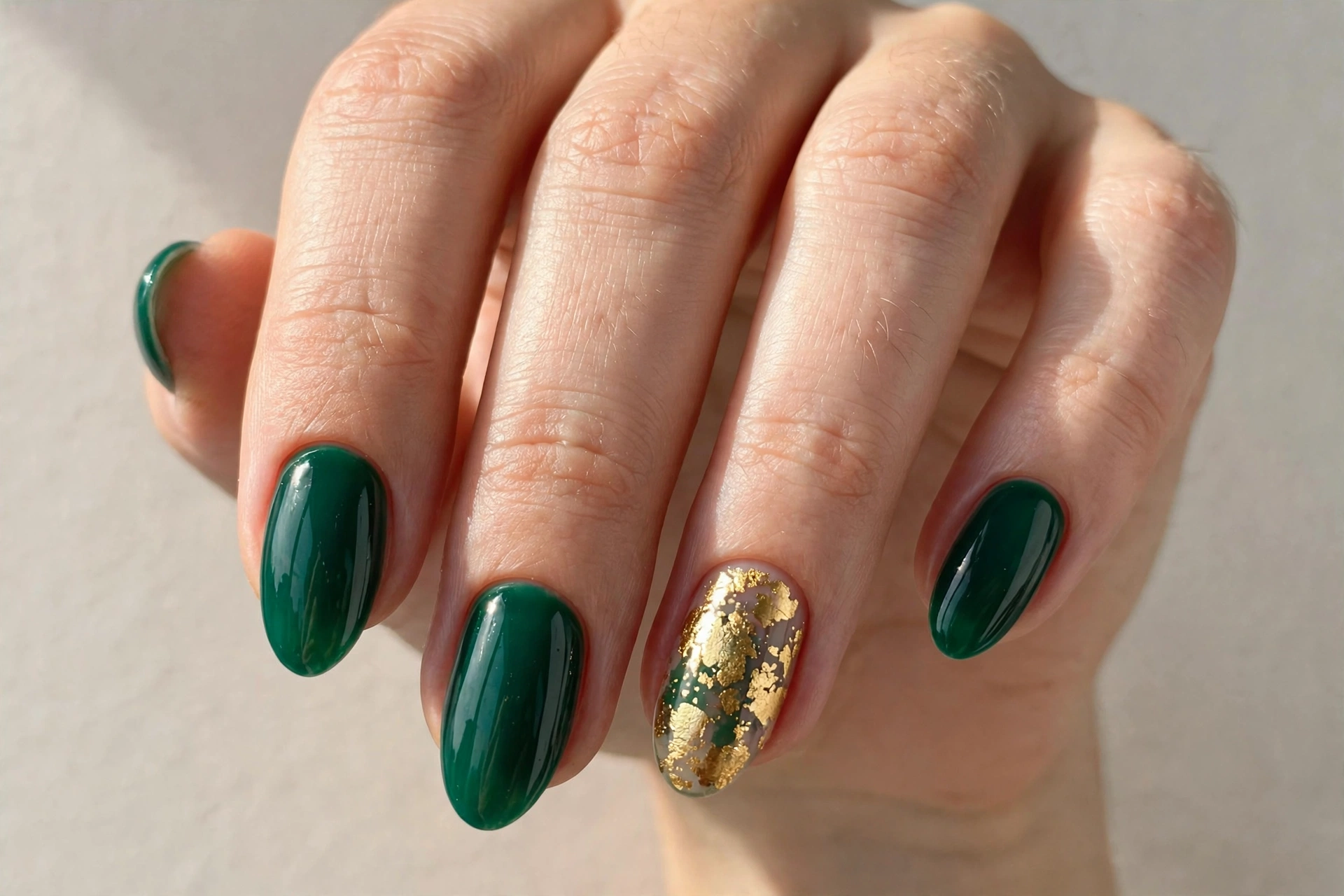Emerald green Christmas nails with gold foil flakes