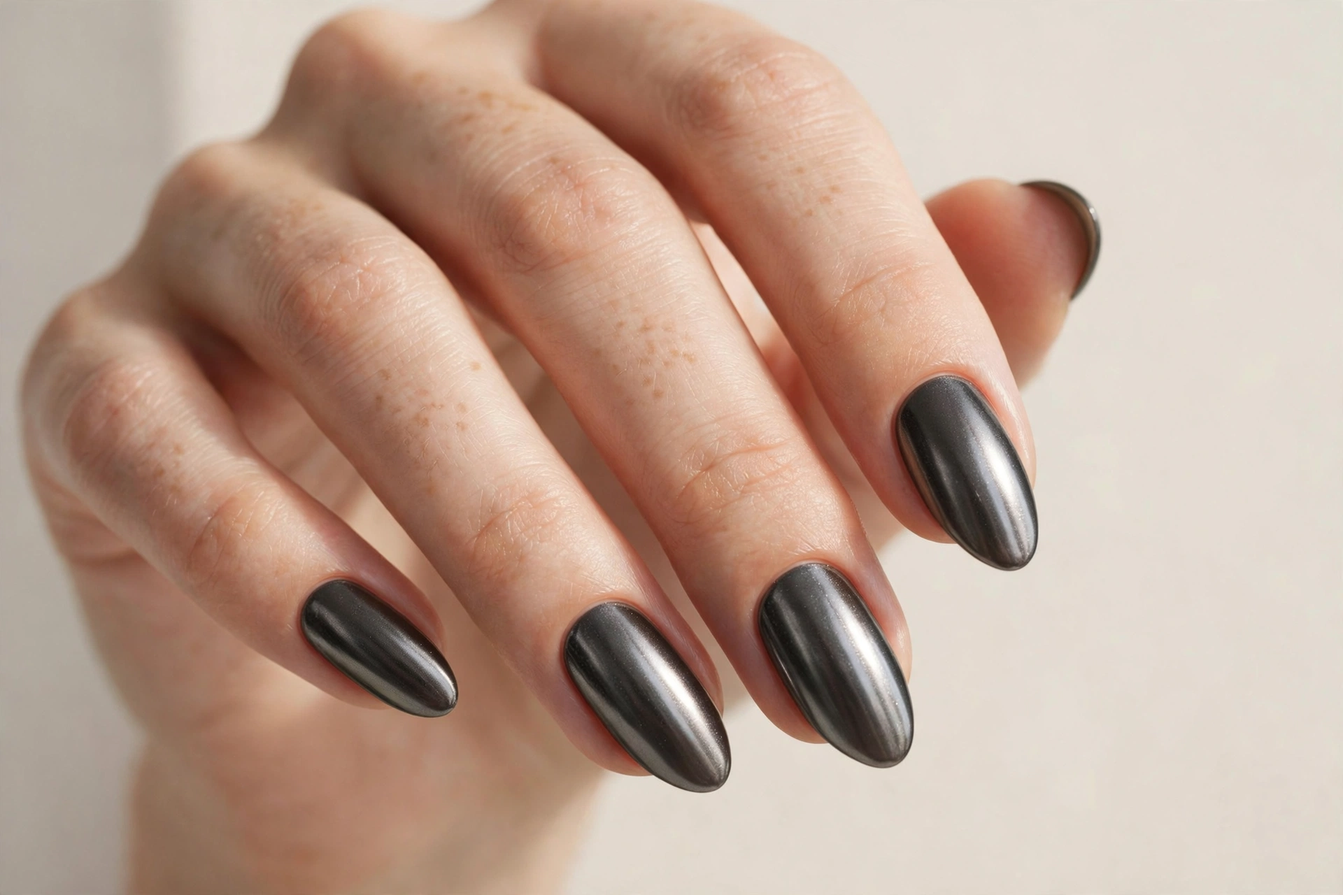 Gunmetal dark grey chrome nails with a smoky metallic finish