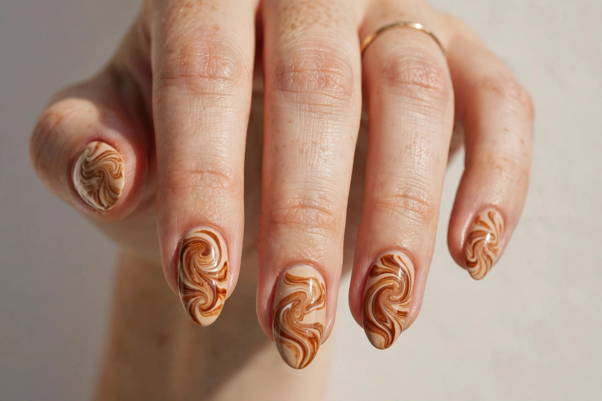 Cinnamon swirl fall nail art in caramel and warm brown