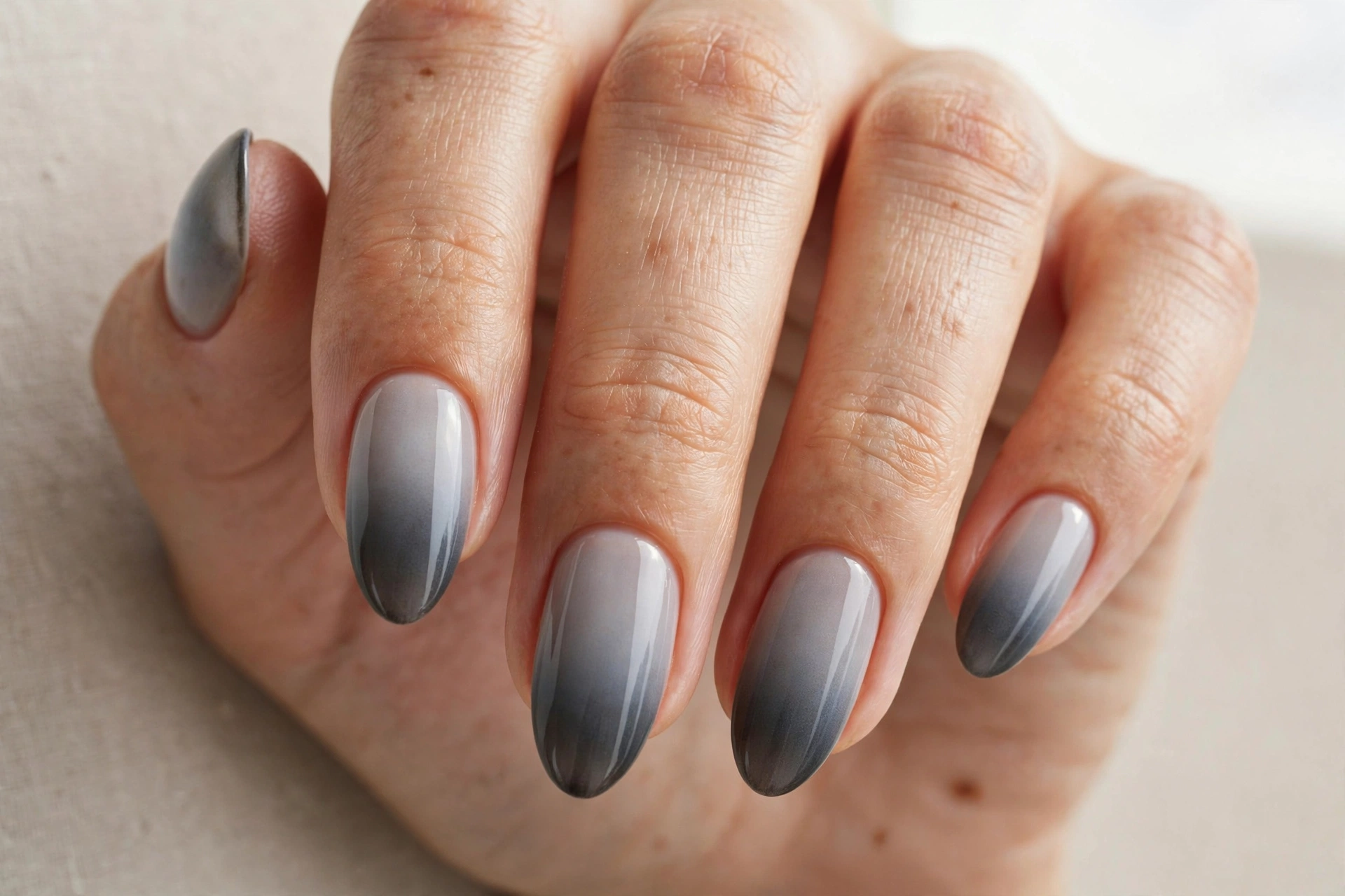 Smoky gray gradient ombre manicure fading from dark to light