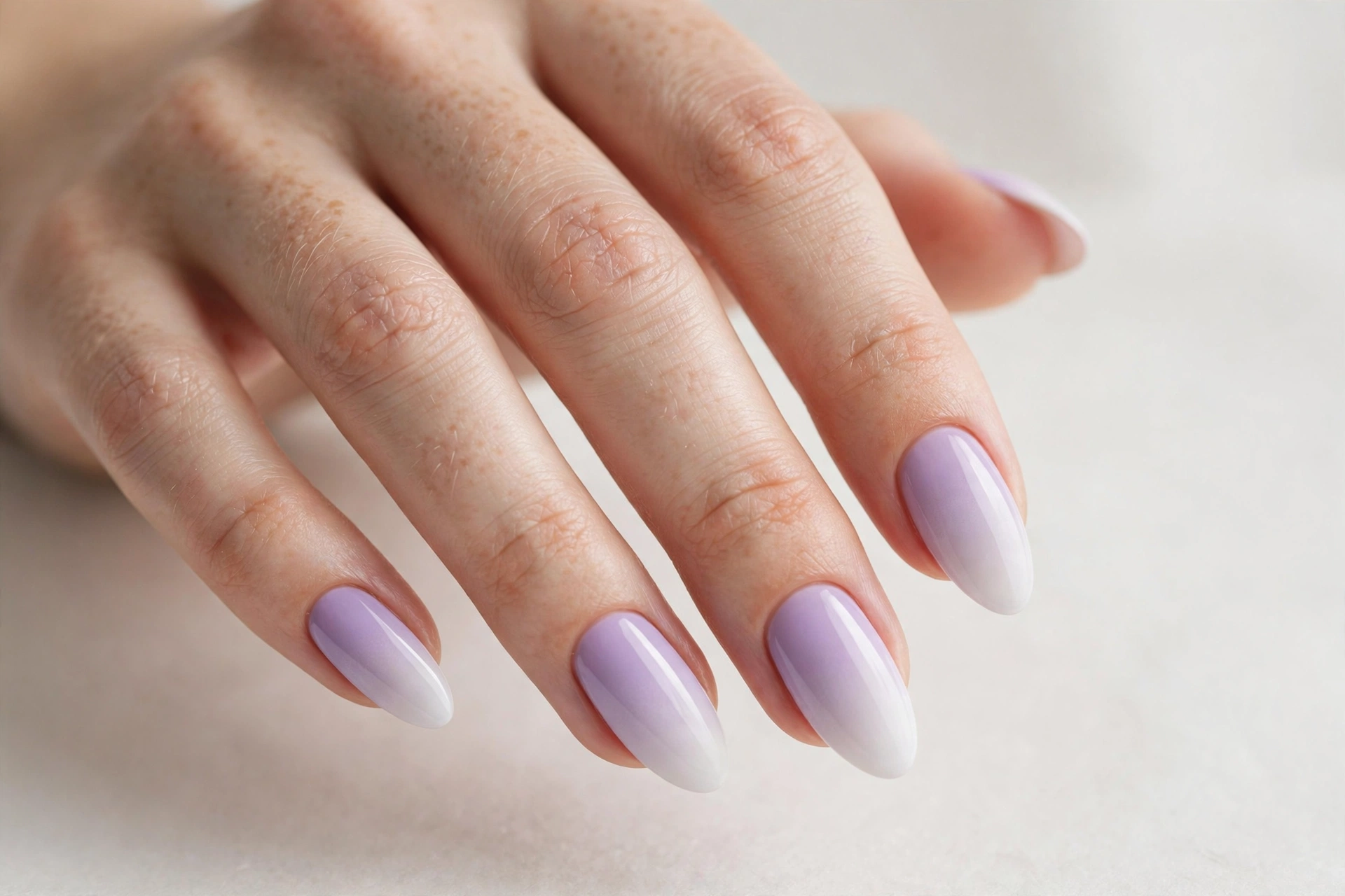 Lilac to white ombre gradient nails on almond nails