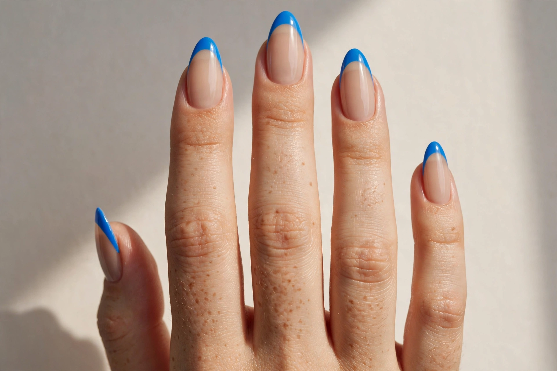 Electric blue French tip cool nail design on nude base