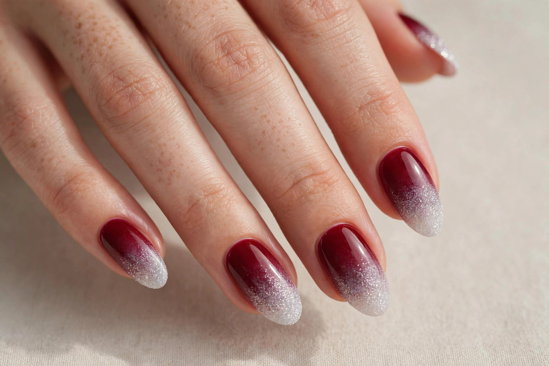 Frosted cranberry to white glitter ombre nails