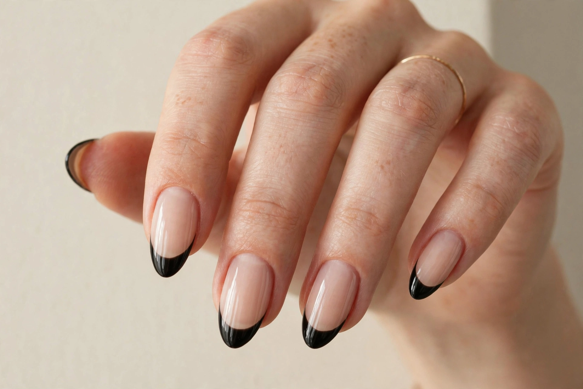 Gold glitter French tip manicure on almond nails