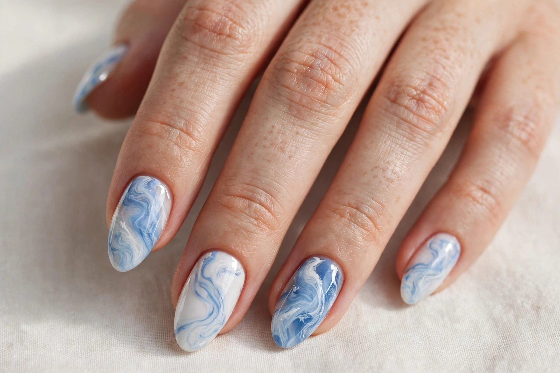 Snowy blue and white marble swirl winter nail art