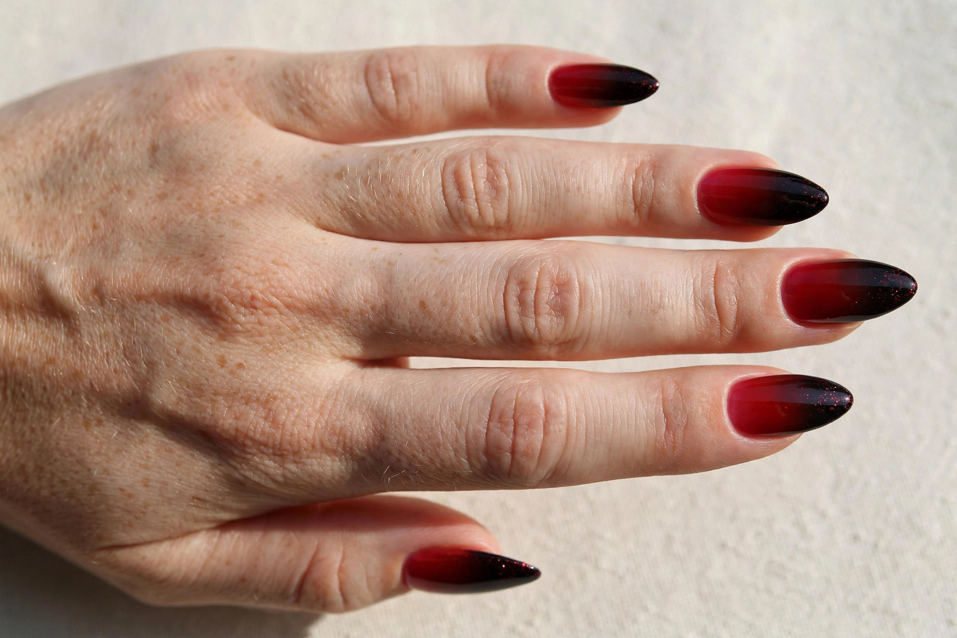 Red ombre nails fading into black tips