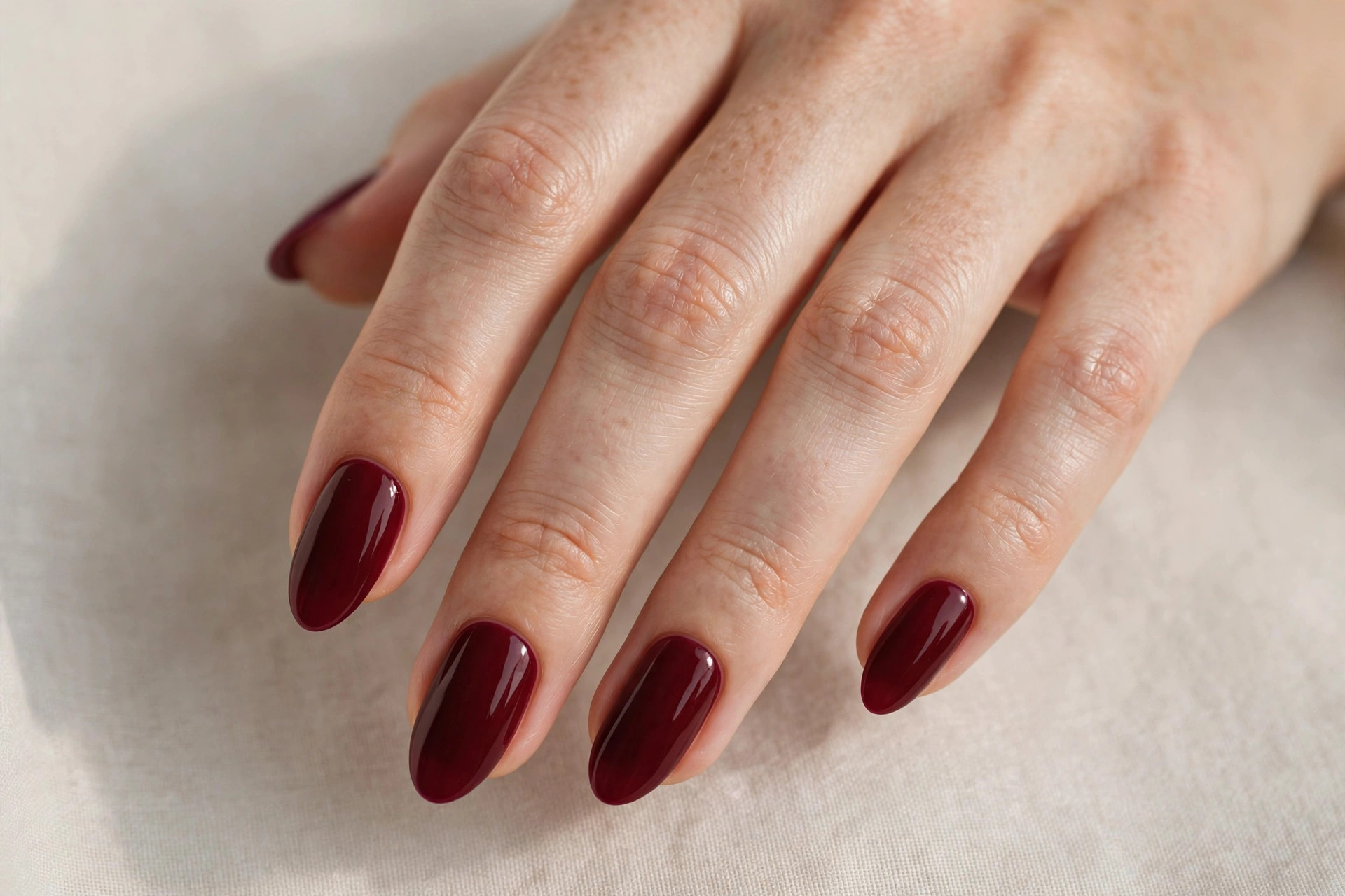 Deep burgundy wine red manicure on almond shaped nails