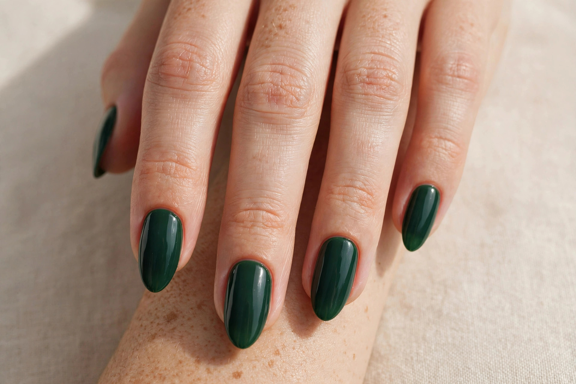 Deep forest green manicure on almond shaped nails