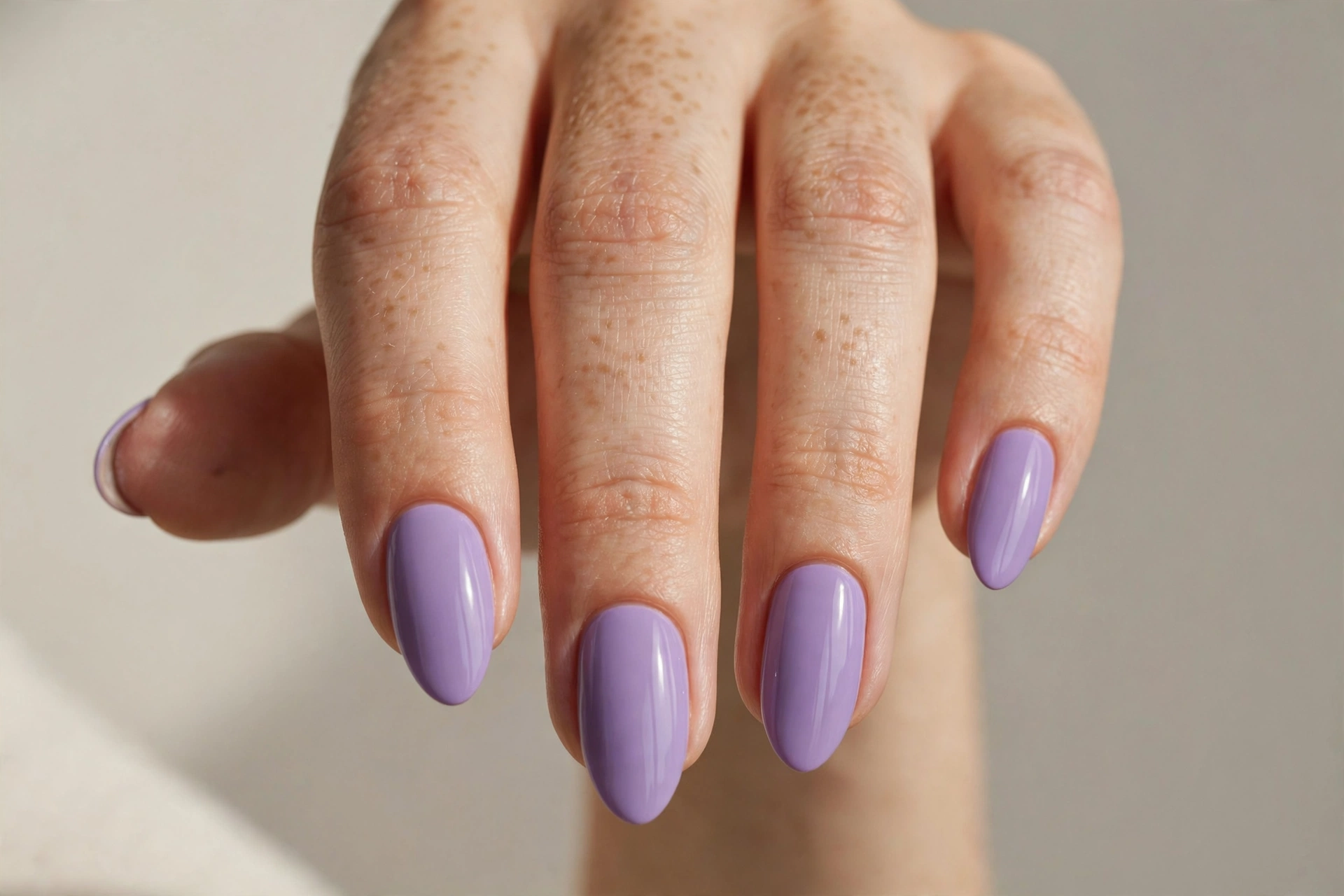 Solid lavender polish manicure on almond nails
