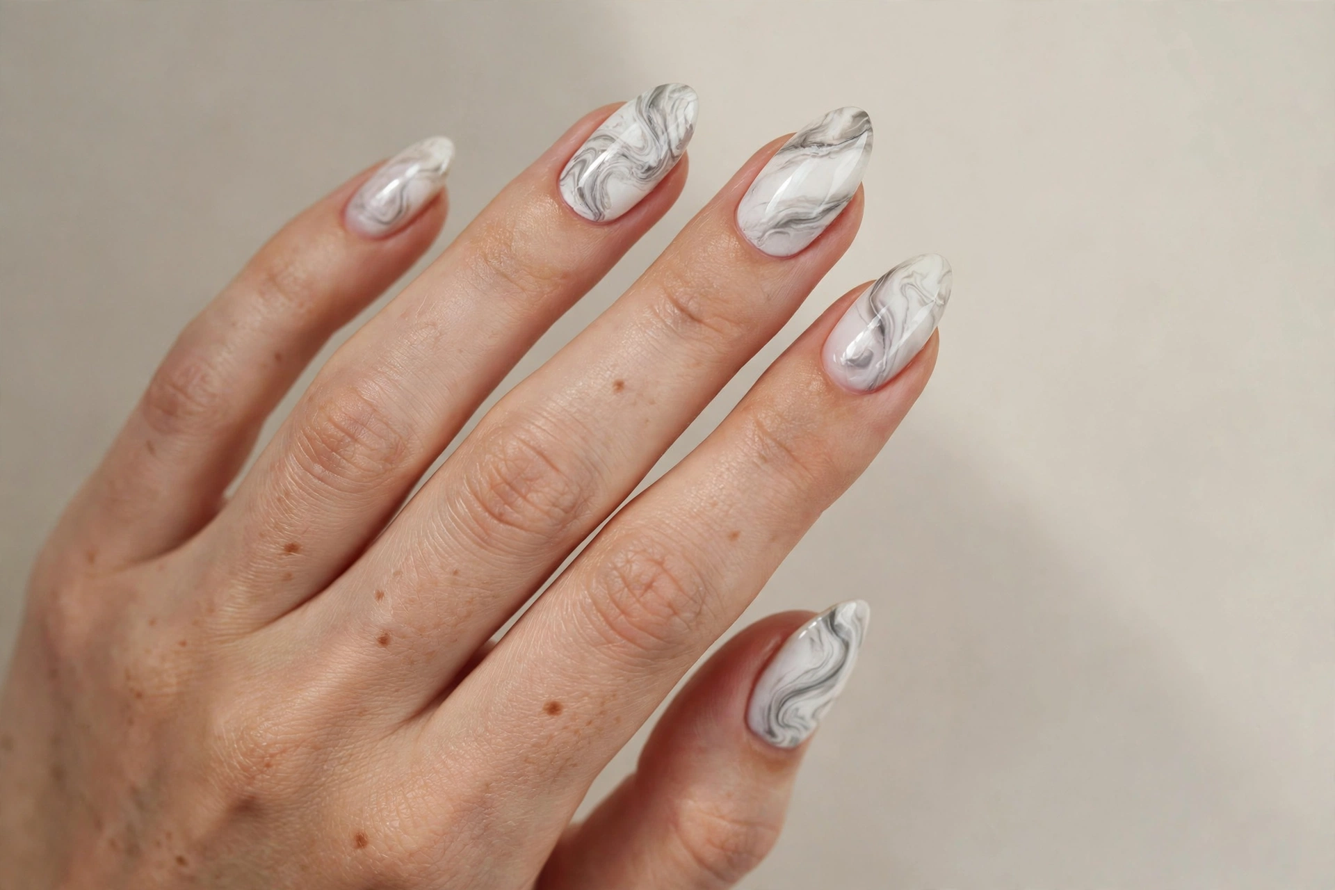 White and gray marble effect manicure on almond nails