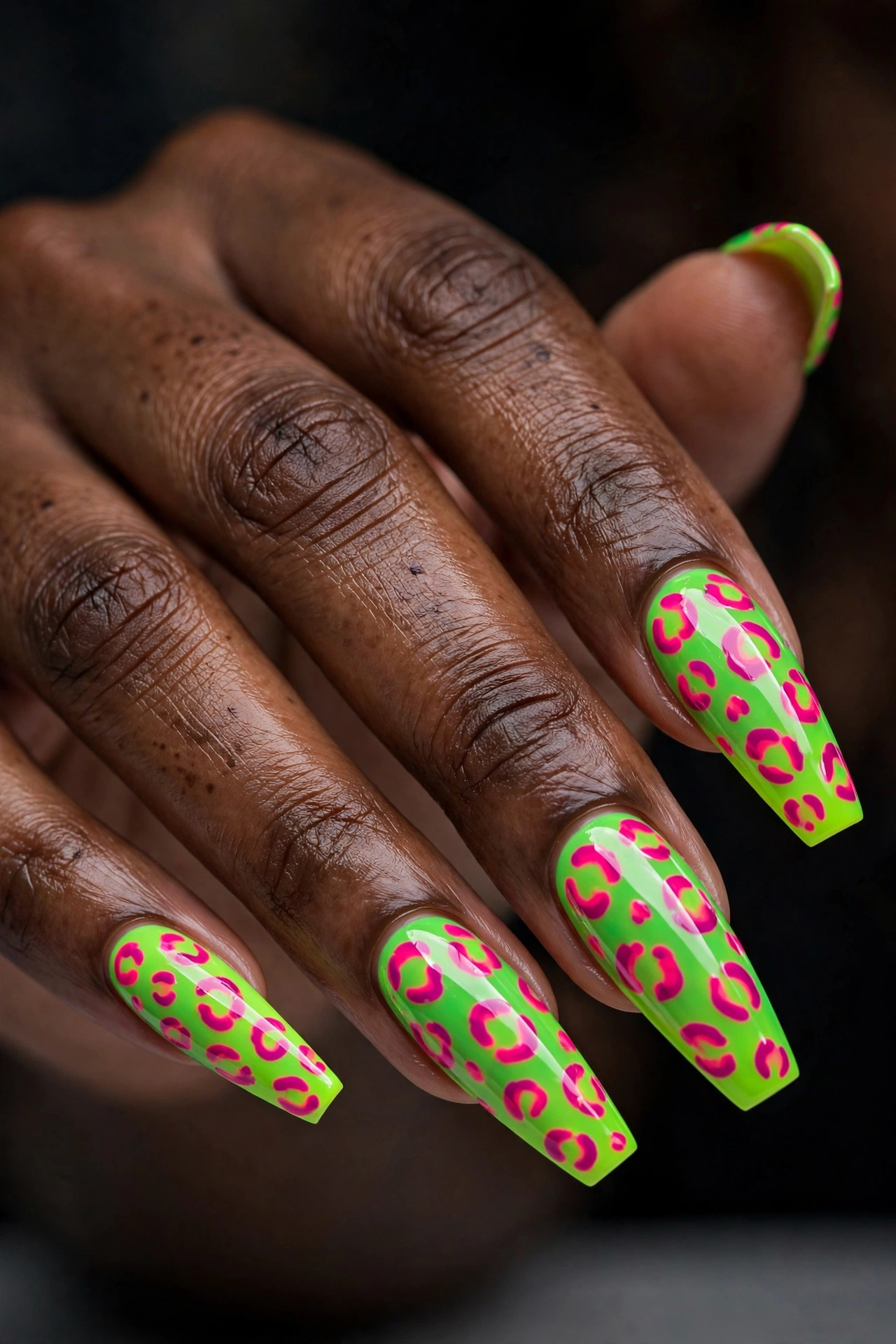 Coffin shaped nails with neon green and pink nail art