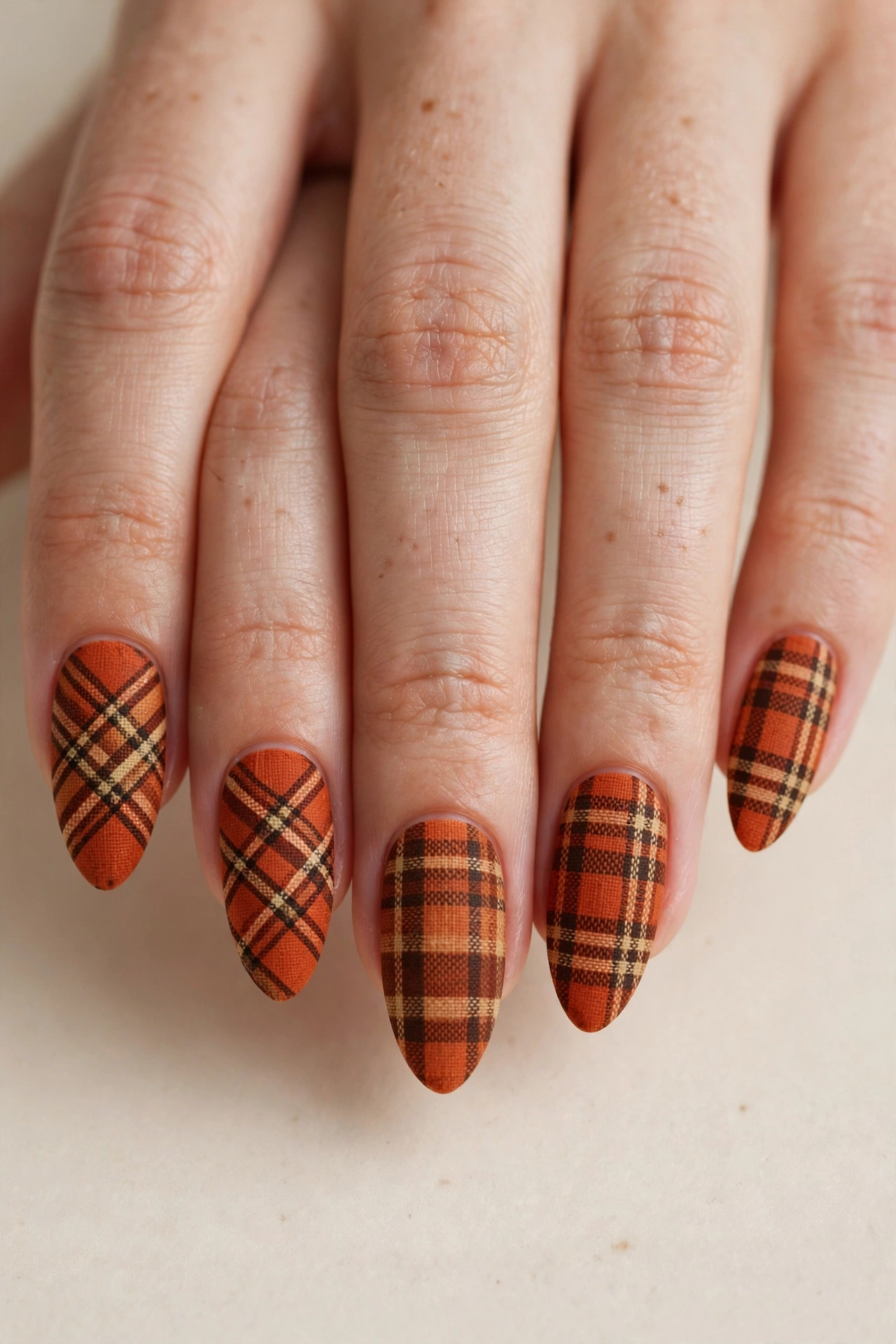 Burnt orange flannel plaid checkered nail art on almond nails