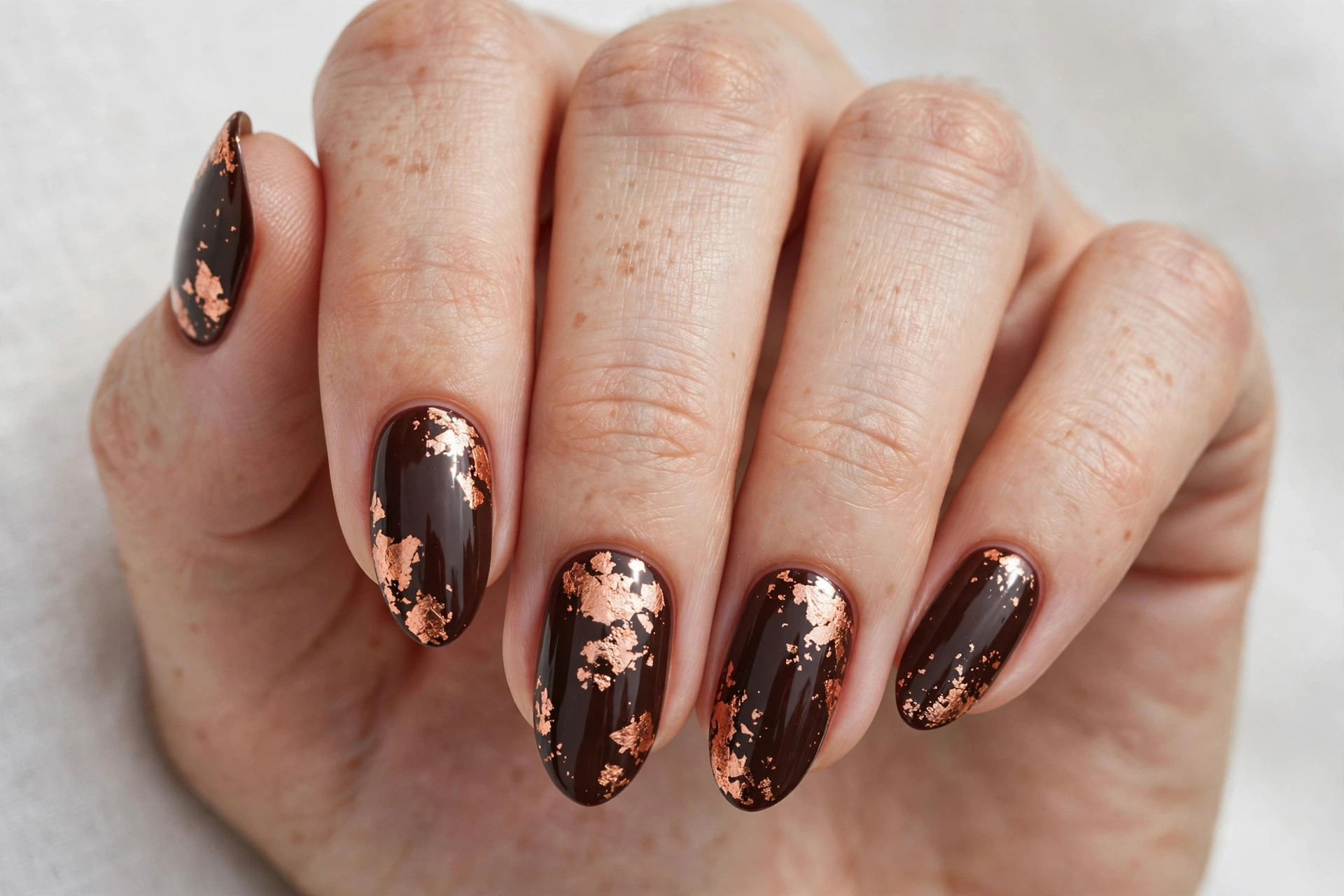 Dark chocolate brown nails with copper leaf foil accents