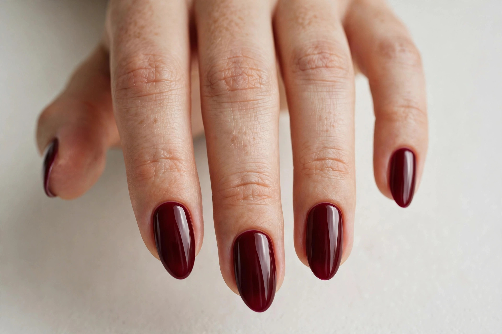Deep burgundy wine fall nail designs on almond shaped nails