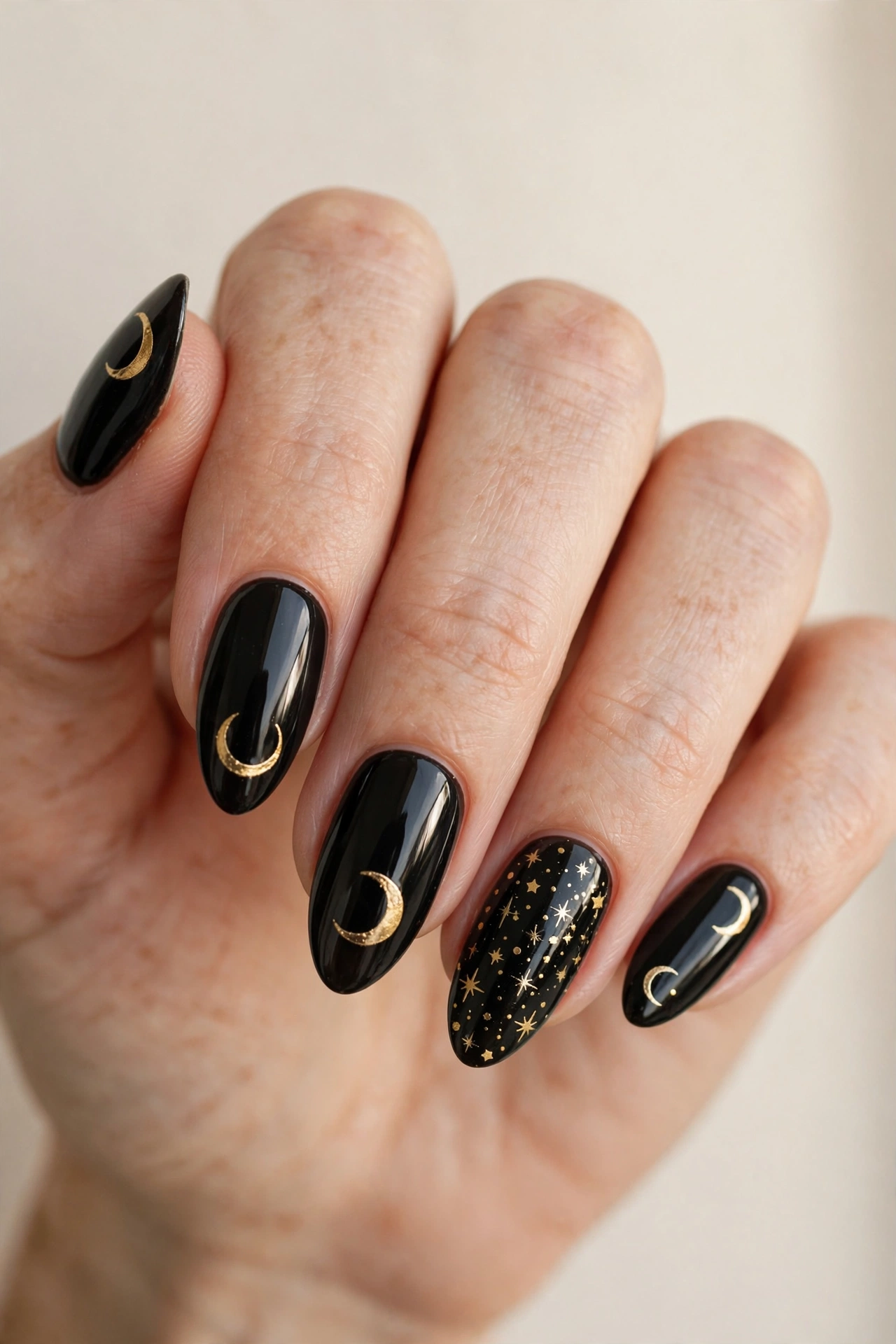 Black nails with gold crescent moon and star art