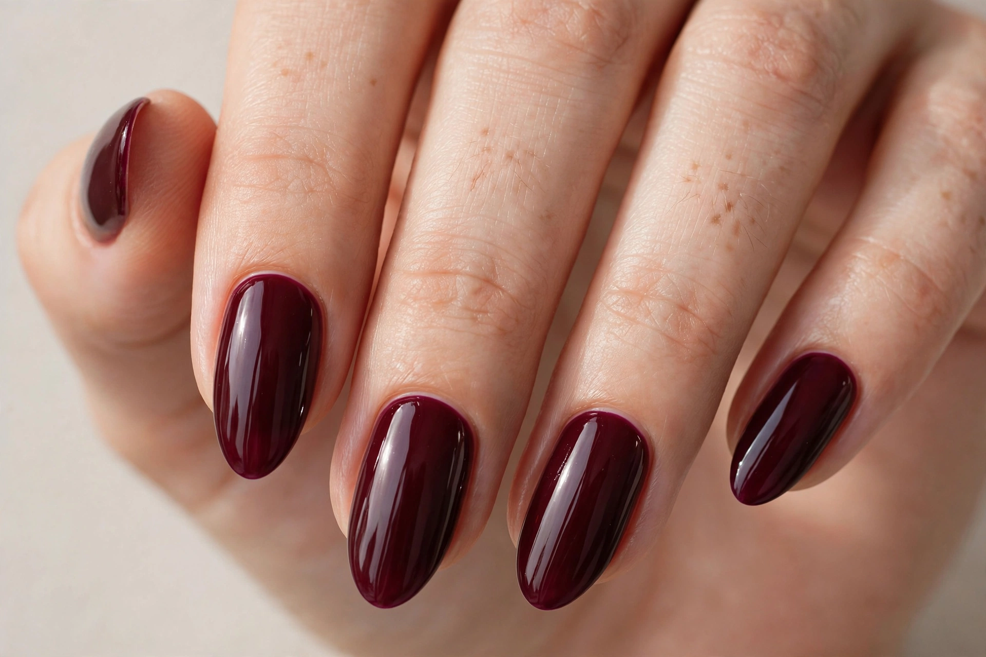 Deep burgundy wine gel nail design on almond nails