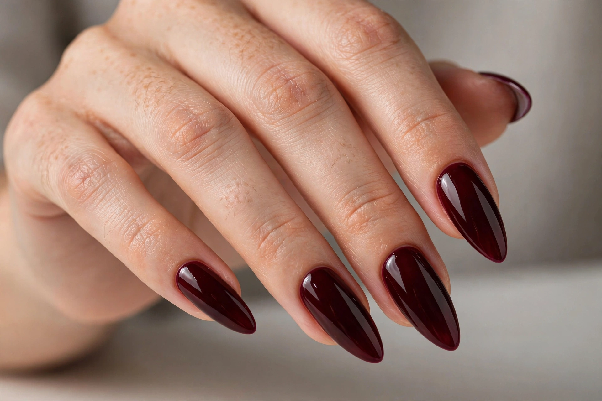 Deep burgundy wine on almond Gel X nail extensions