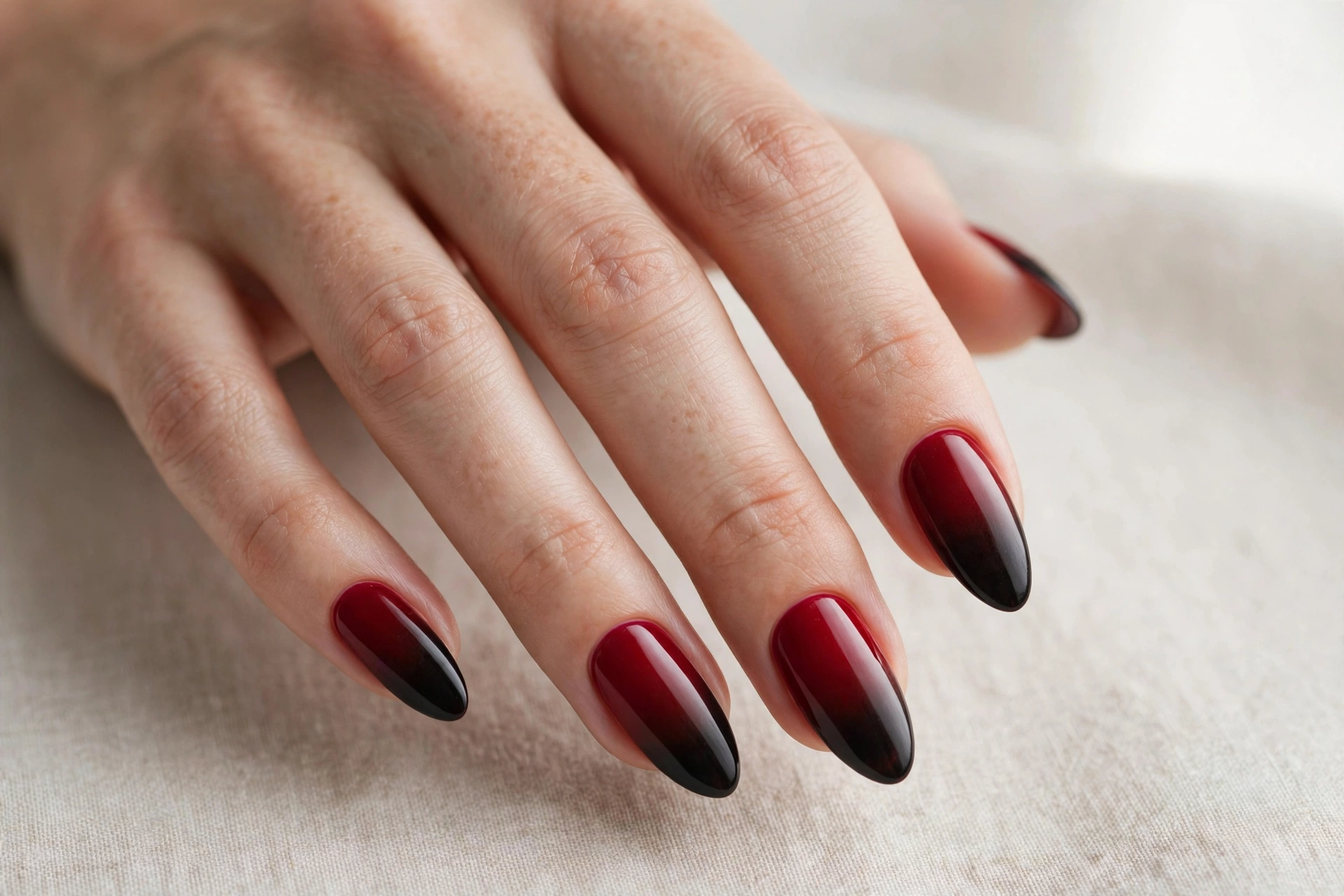 Blood red to black ombre gradient manicure on almond nails