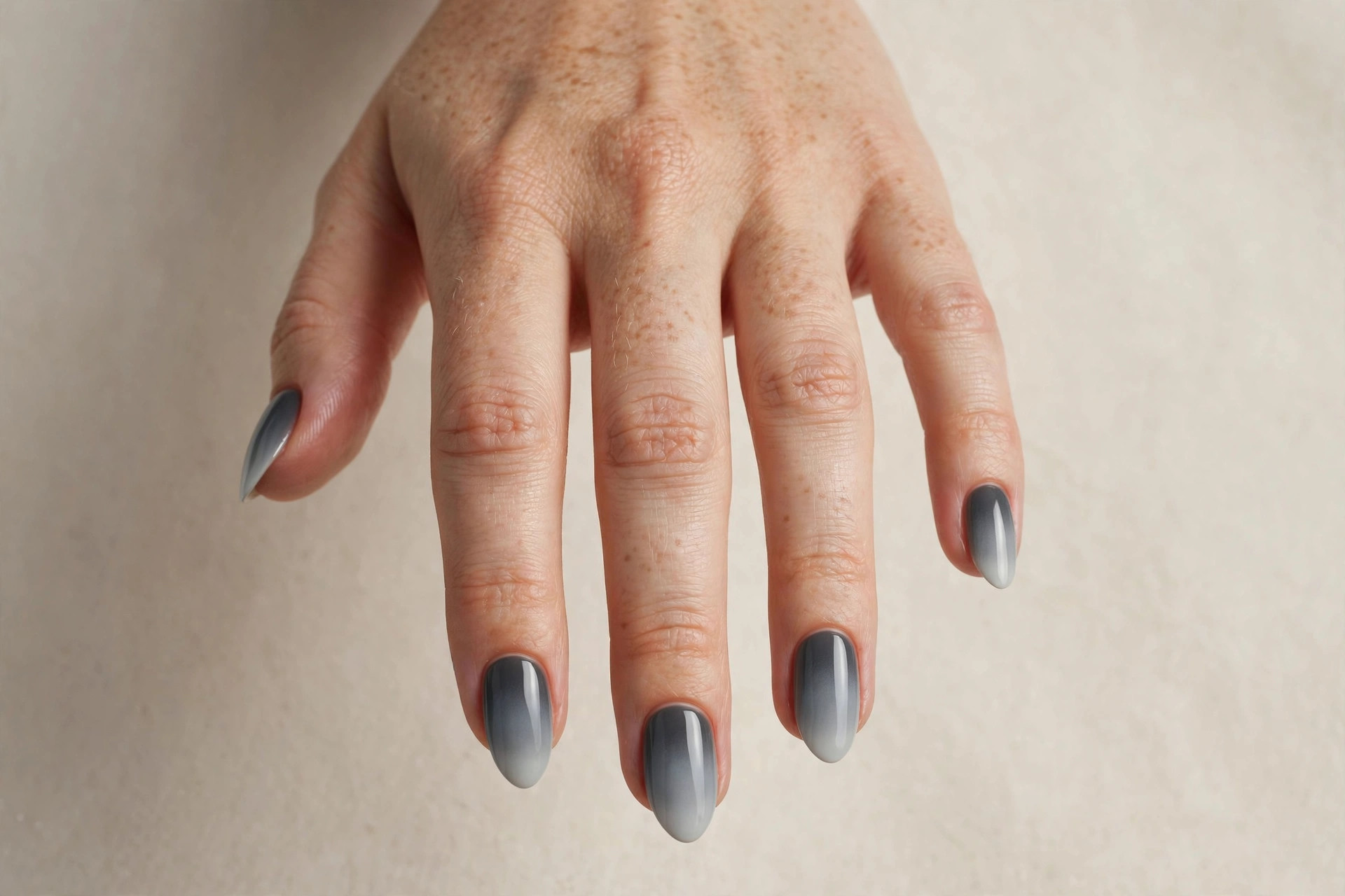 Almond nails with a soft grey gradient winter manicure fading dark to light