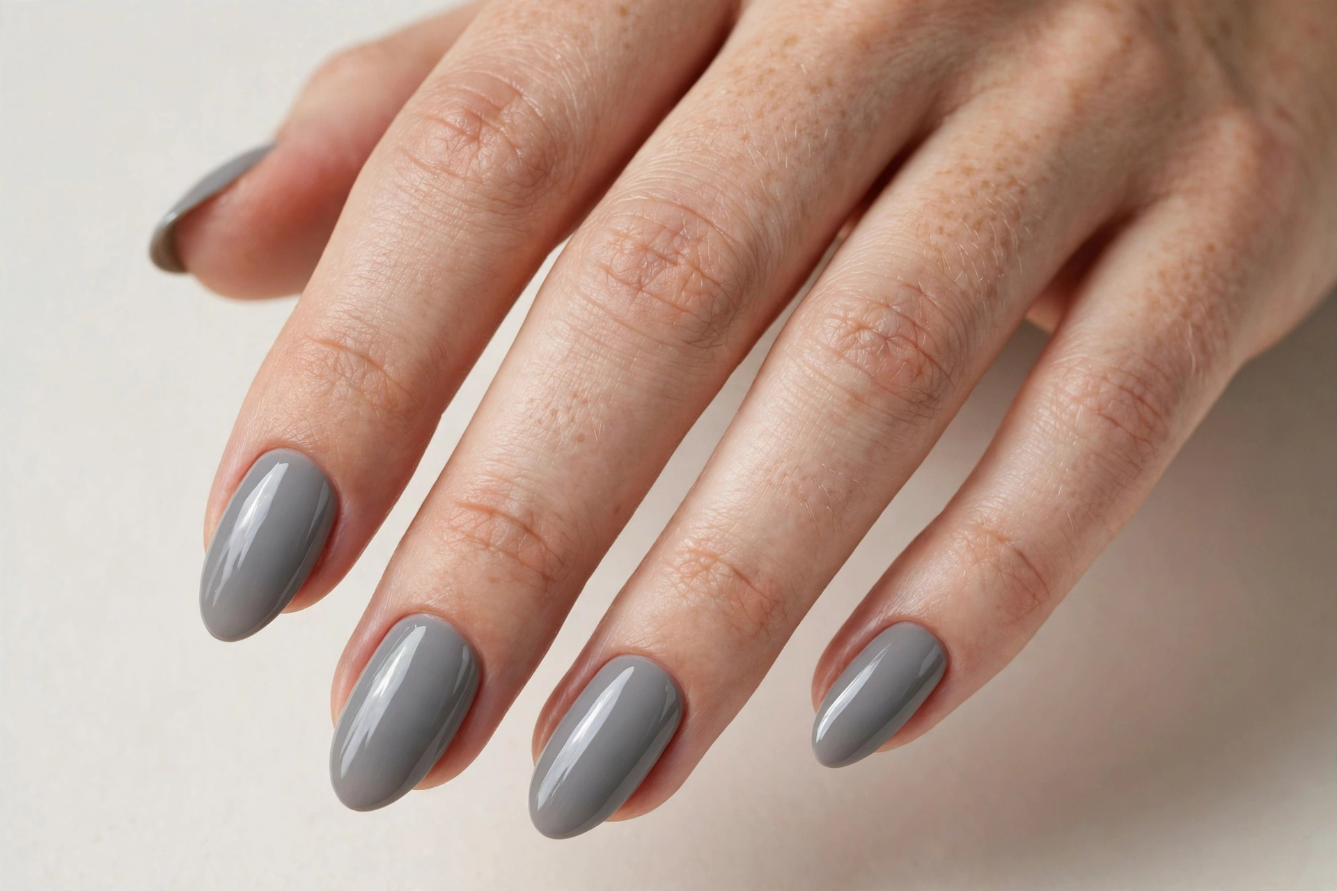 Classic glossy dove gray manicure on almond shaped nails
