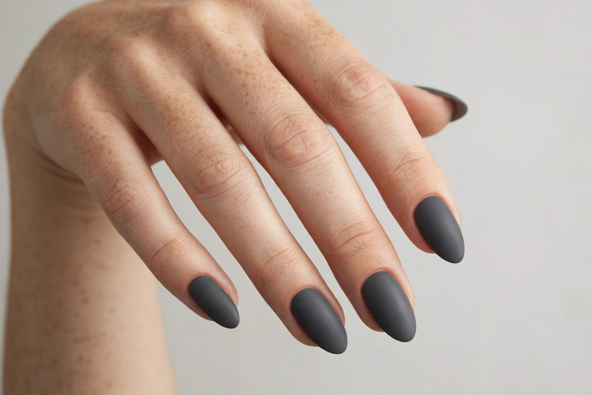 Charcoal gray matte manicure on almond shaped nails