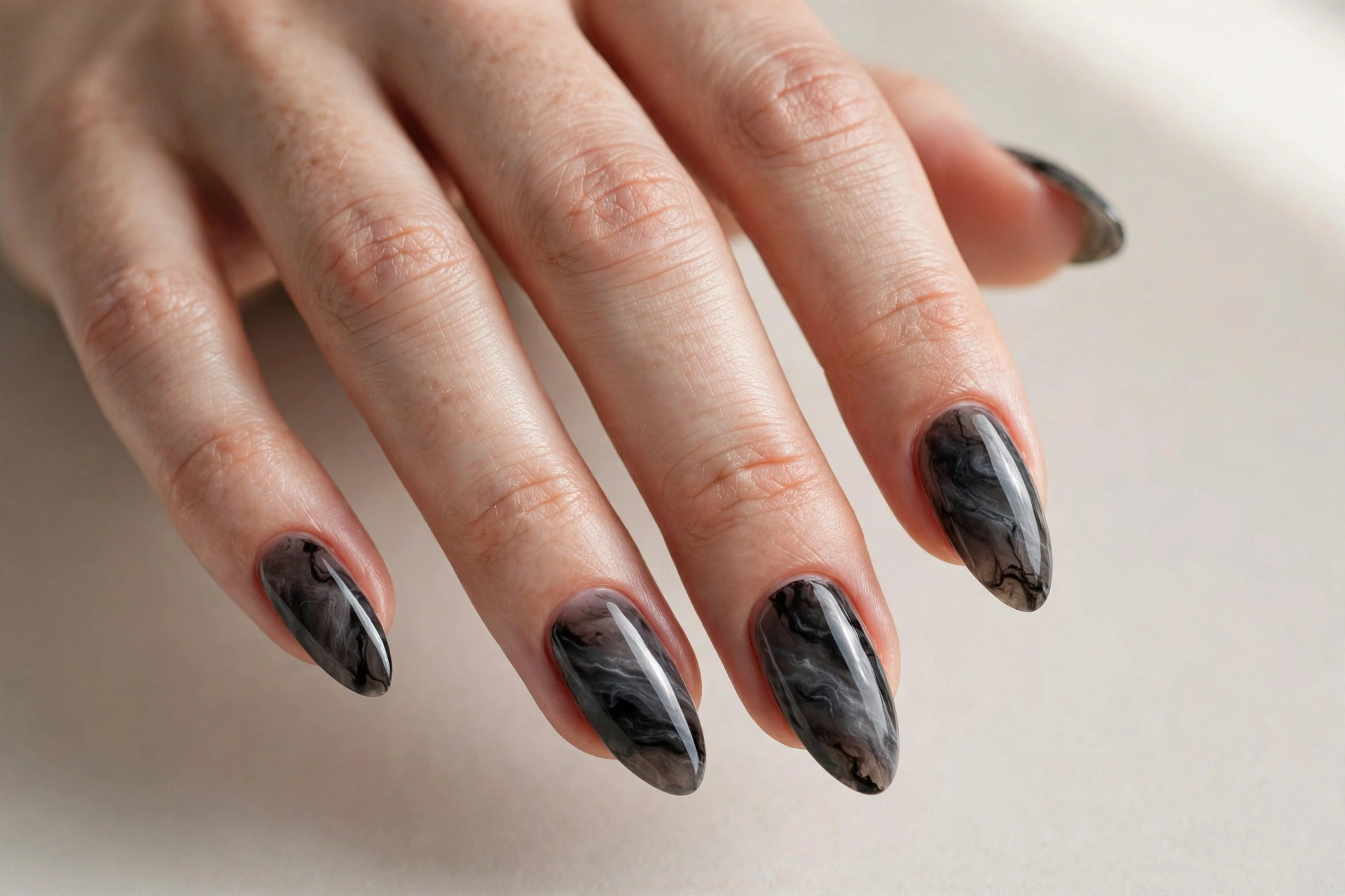 Dark gray and black smoky marble manicure on almond shaped nails