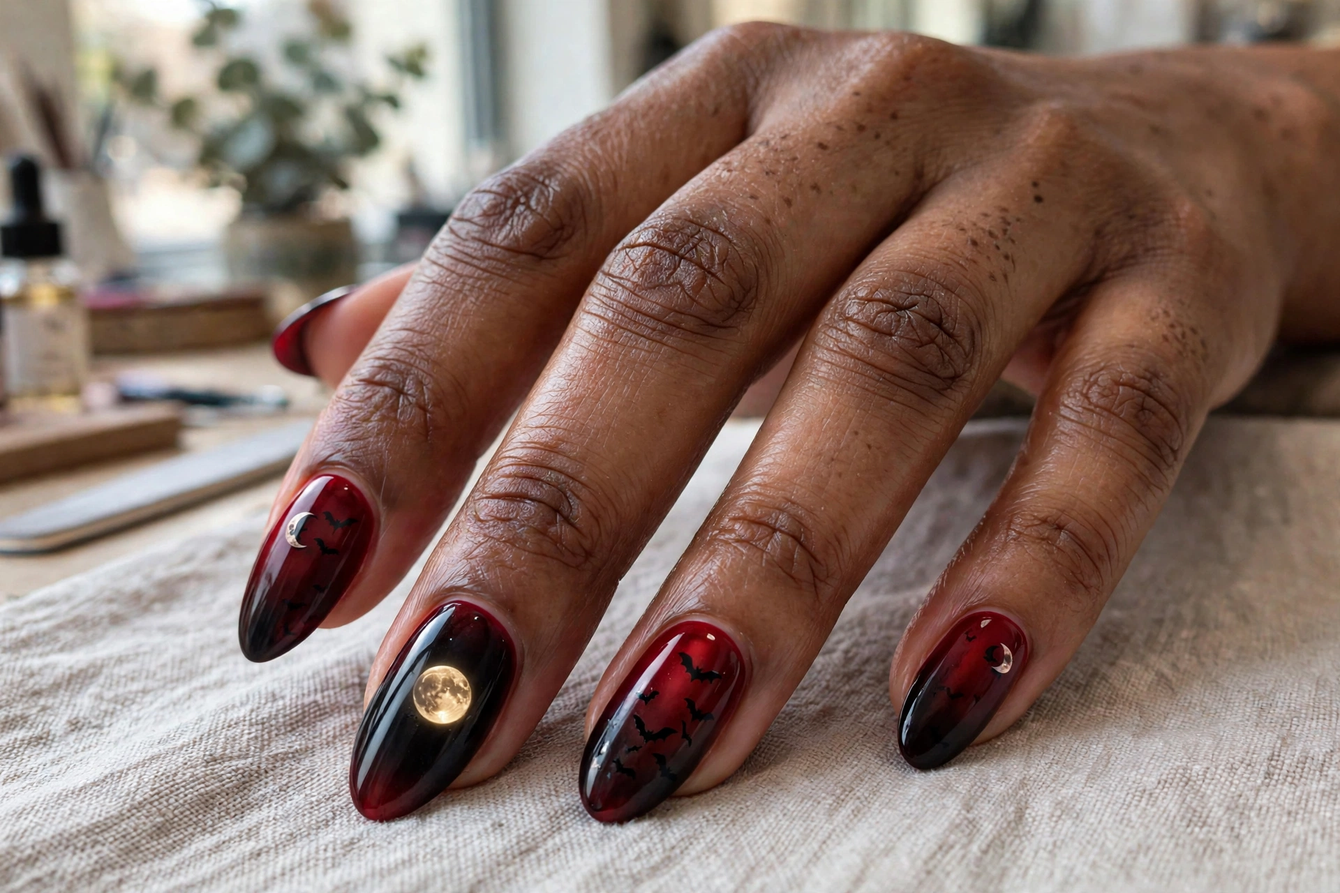 Blood moon Halloween nail design with red gradient moon and bats