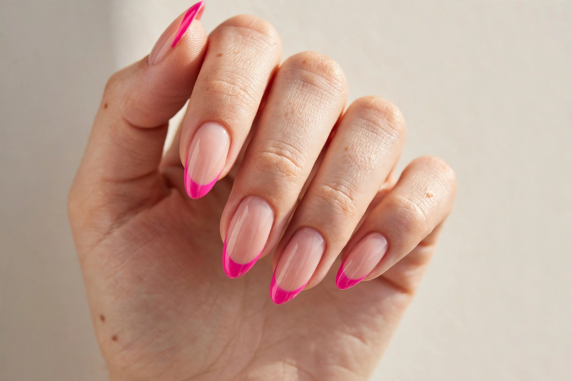 Hot pink french tip manicure on a nude base