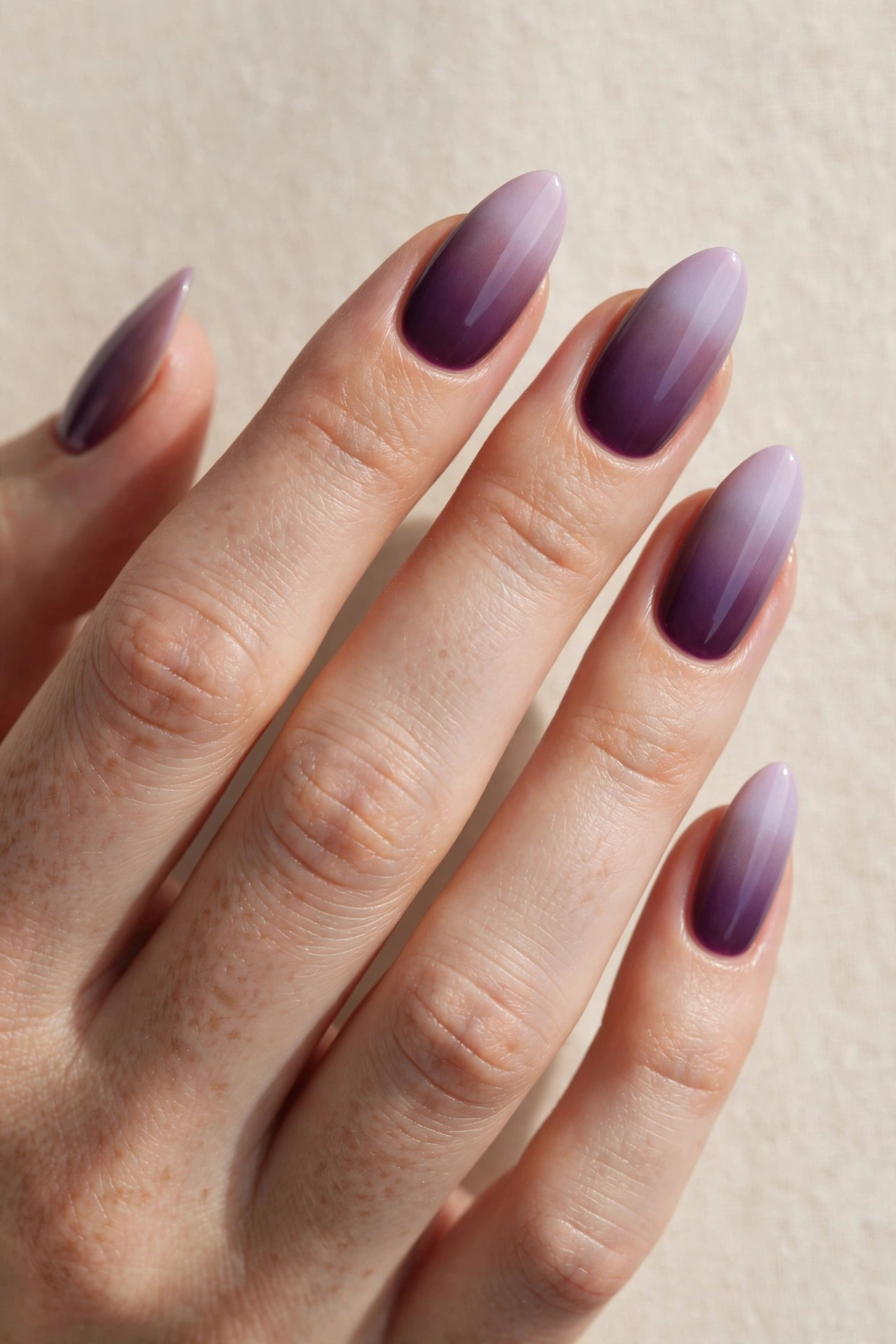 Vertical gradient manicure fading from deep plum purple to pale lavender