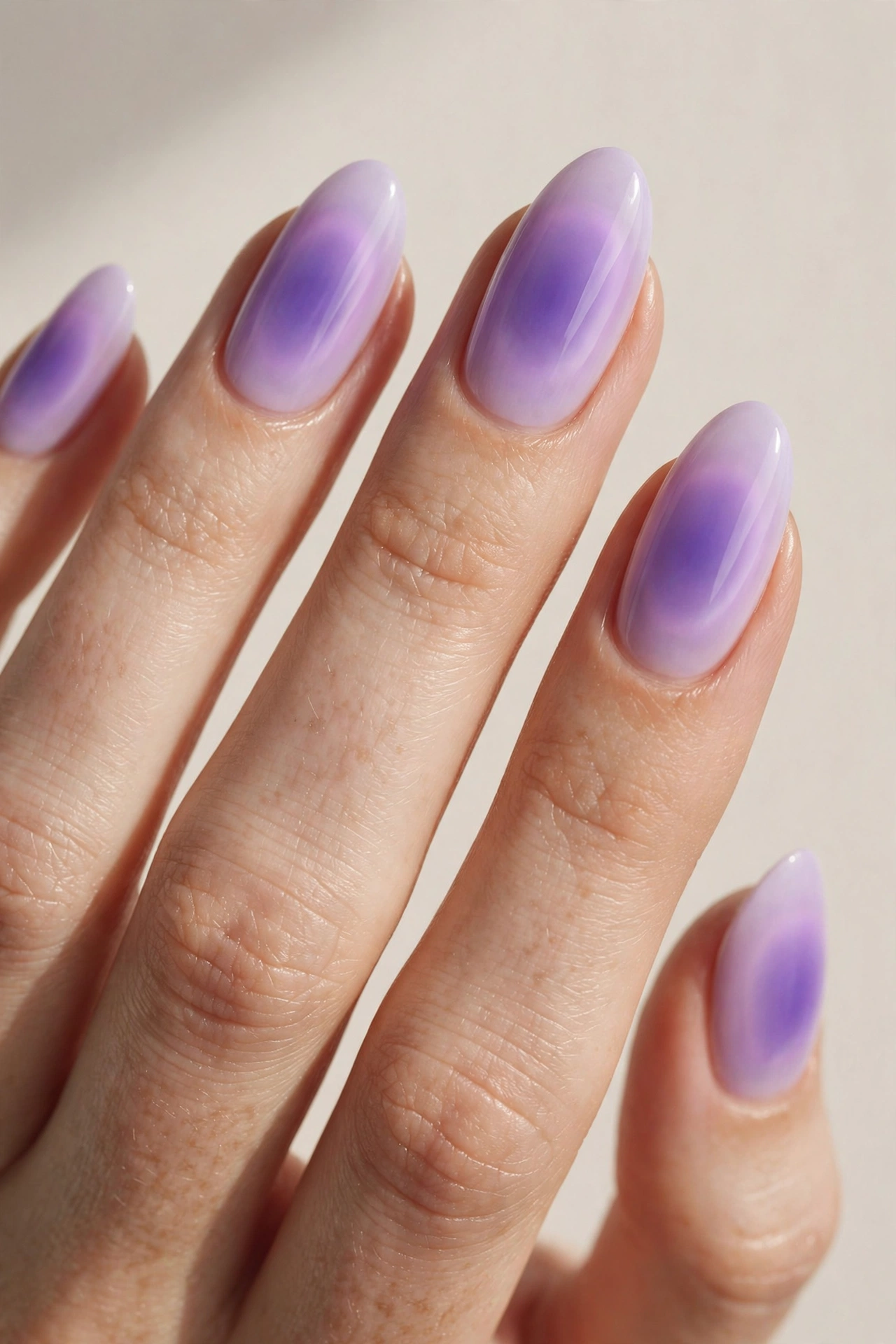 Lavender aura nails with soft glowing purple halo in the center